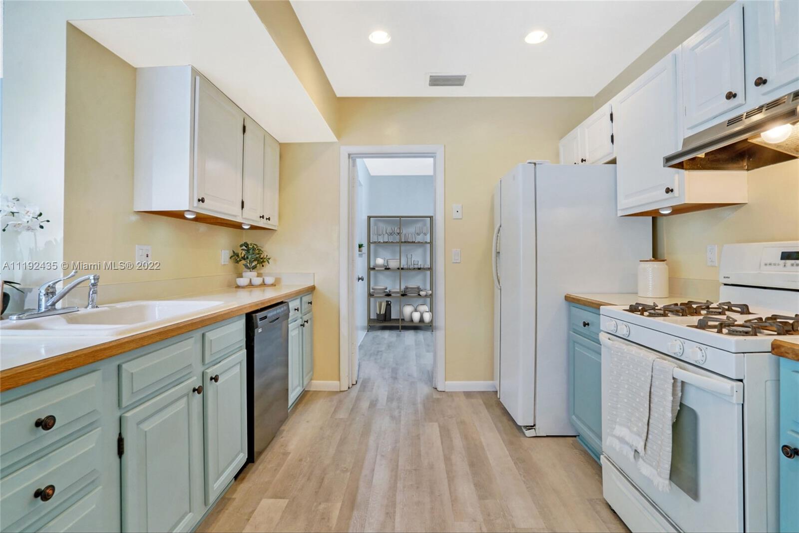 5211 Northeast 26th Avenue Lighthouse Point, FL 33064 - Photo 16 of 43 a kitchen with cabinets and wooden floor