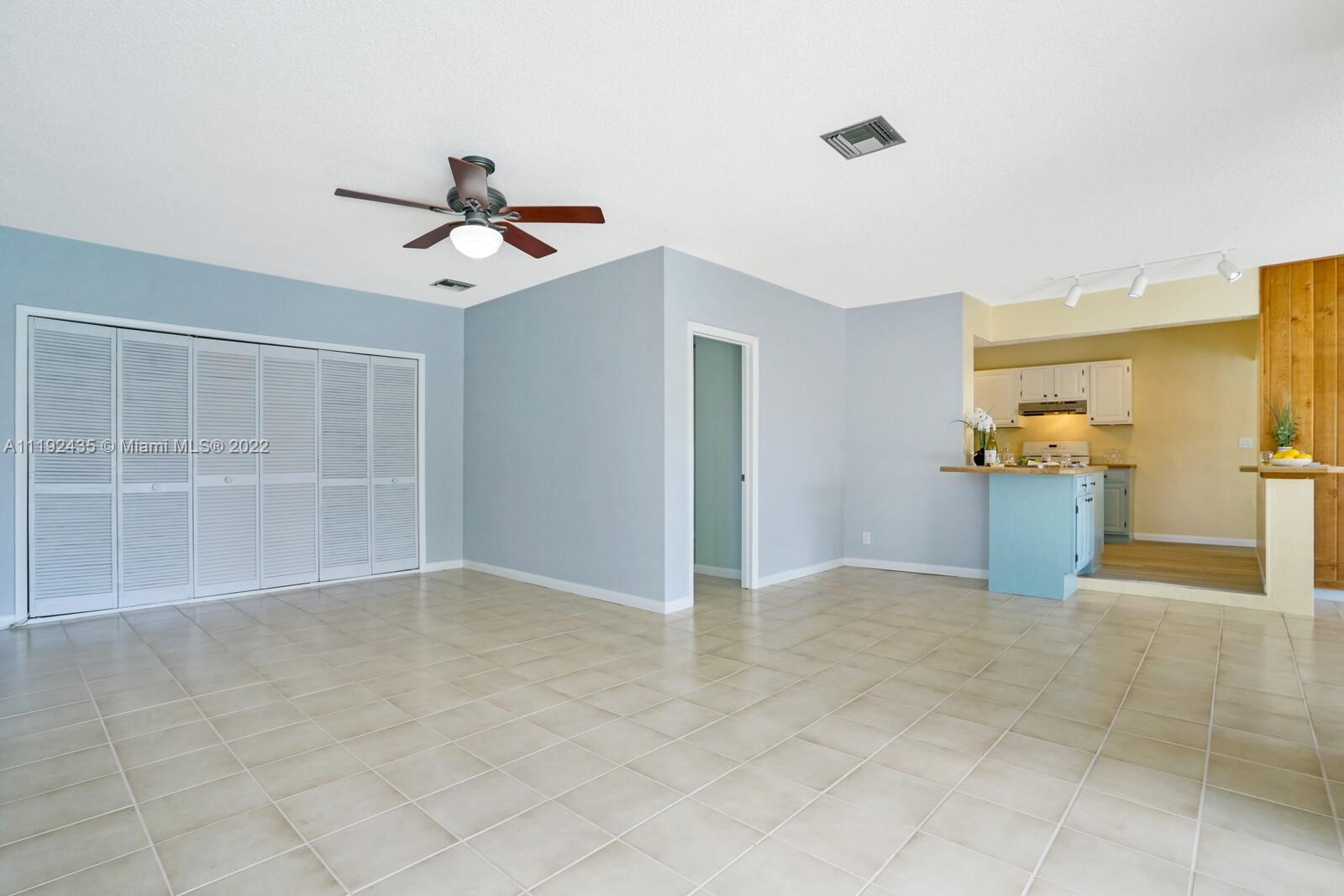5211 Northeast 26th Avenue Lighthouse Point, FL 33064 - Photo 25 of 43 wooden floor in an empty room with a window
