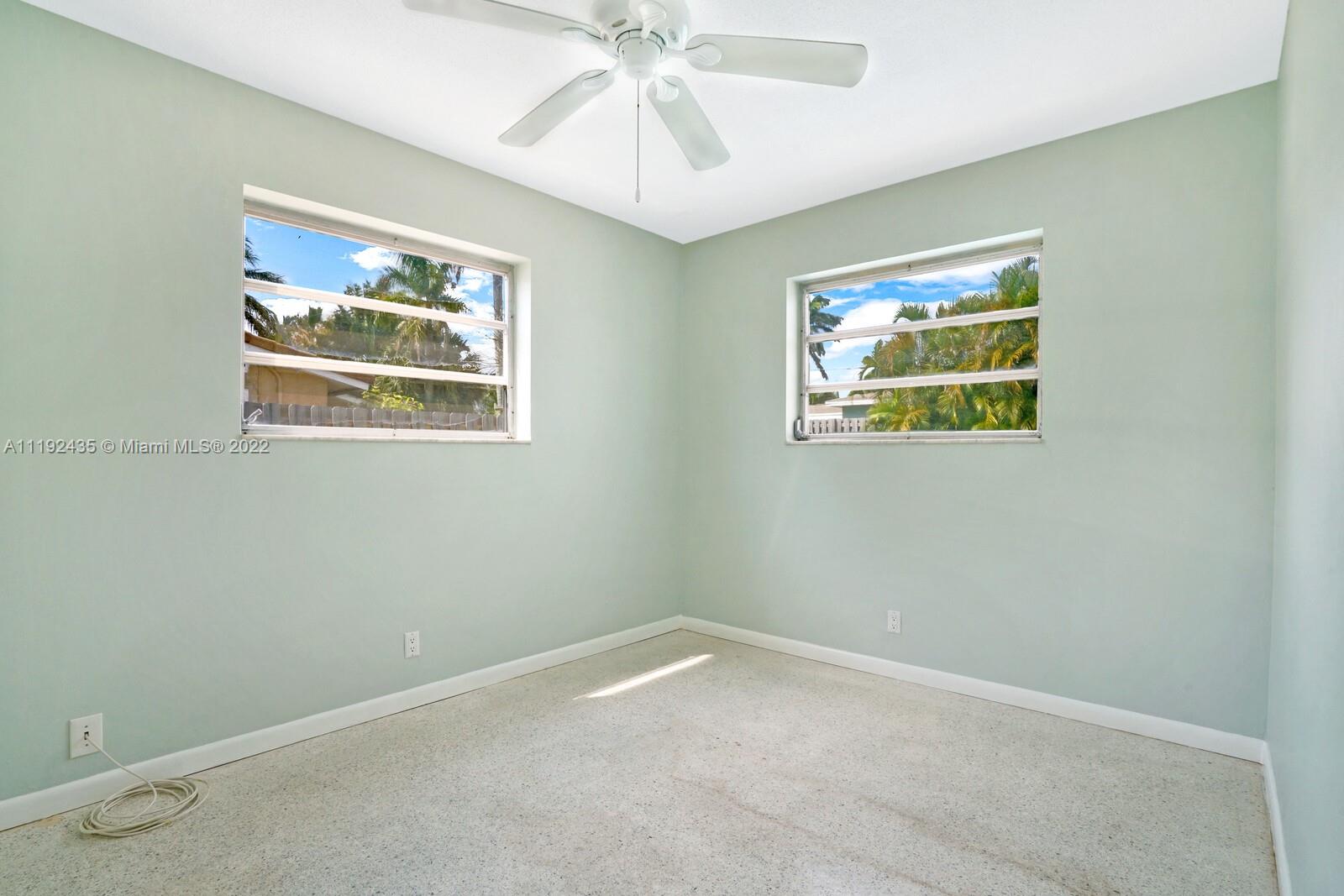 5211 Northeast 26th Avenue Lighthouse Point, FL 33064 - Photo 29 of 43 an empty room with window and wall painting