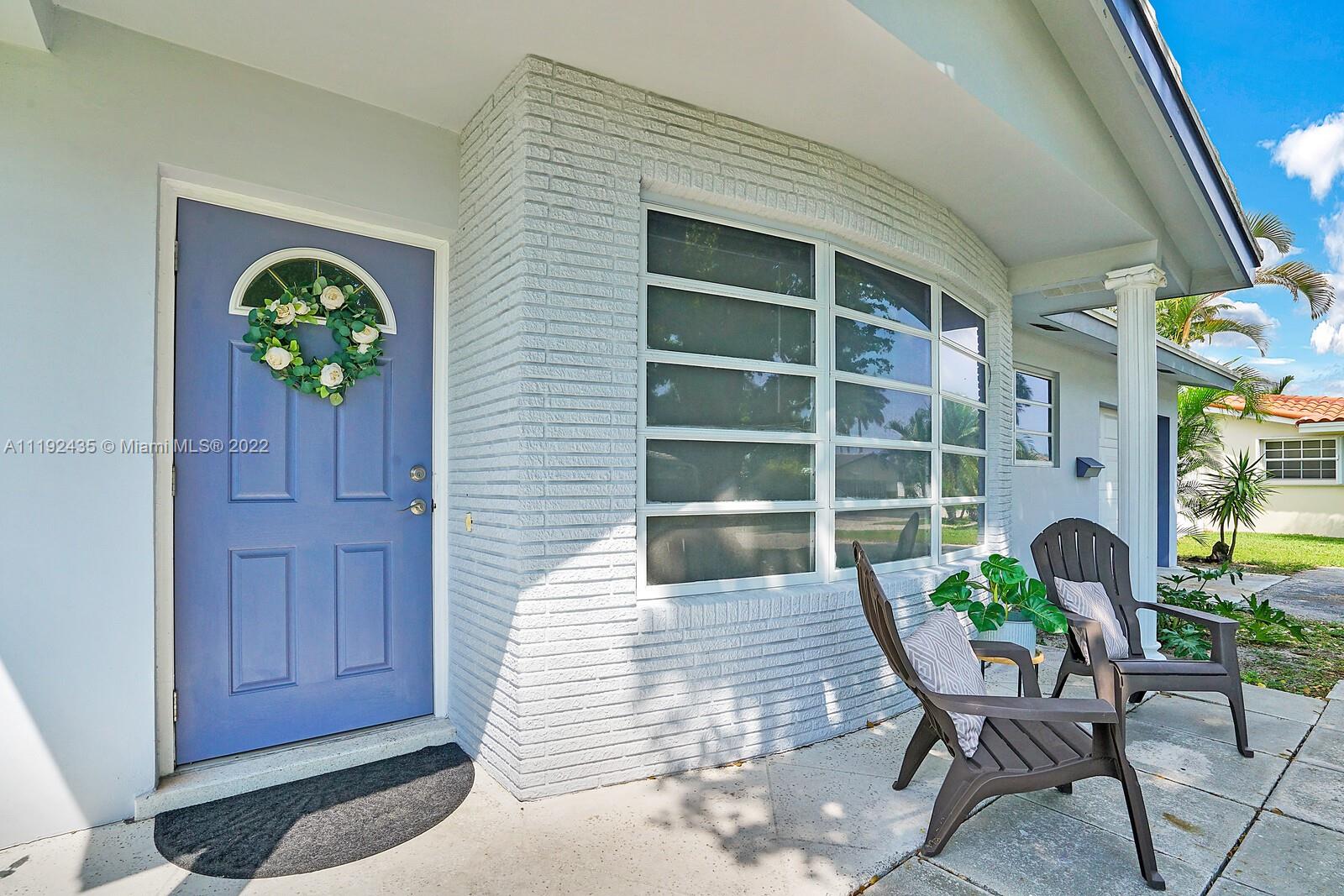 5211 Northeast 26th Avenue Lighthouse Point, FL 33064 - Photo 3 of 43 a balcony with furniture and potted plants