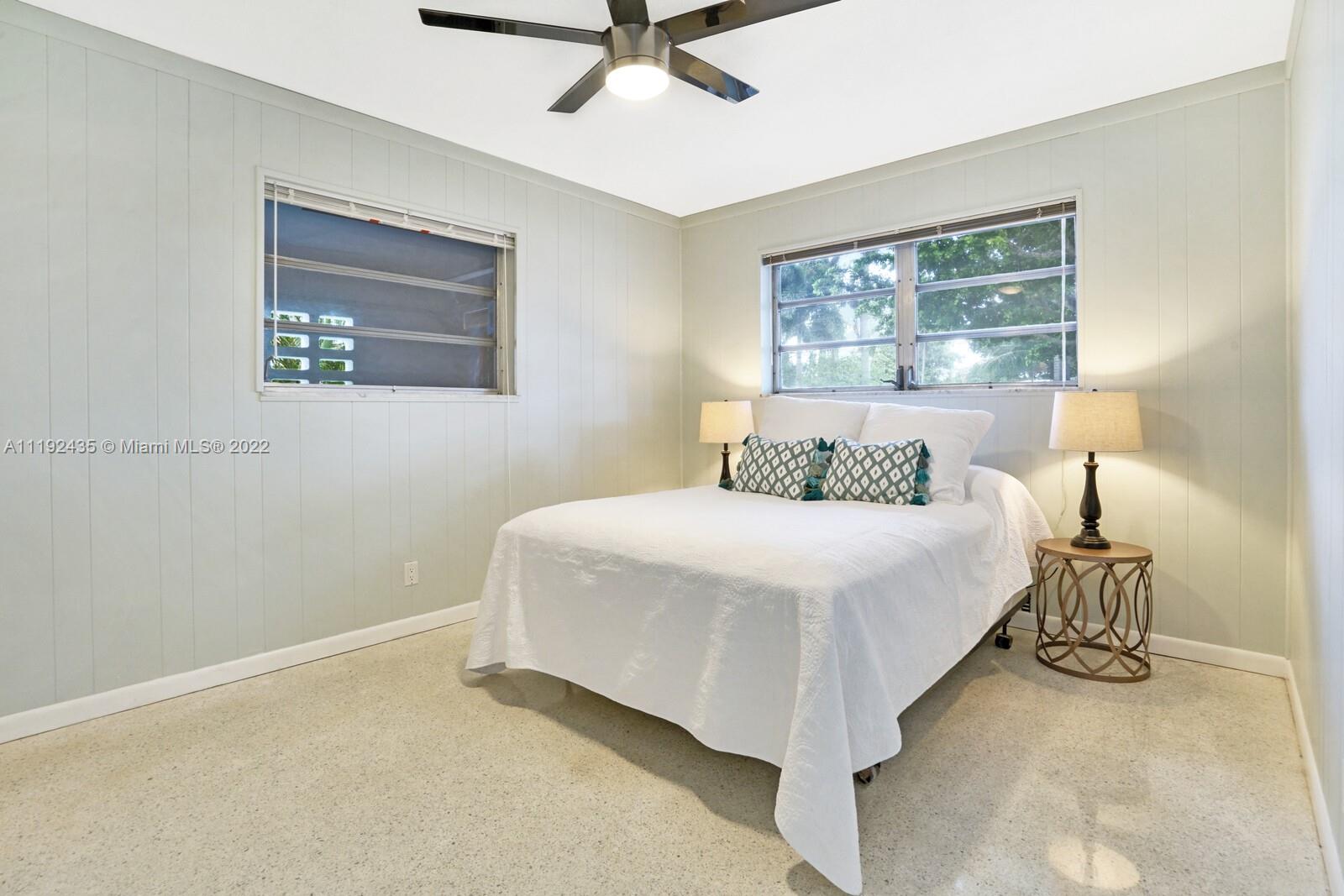 5211 Northeast 26th Avenue Lighthouse Point, FL 33064 - Photo 31 of 43 a bedroom with a bed and window