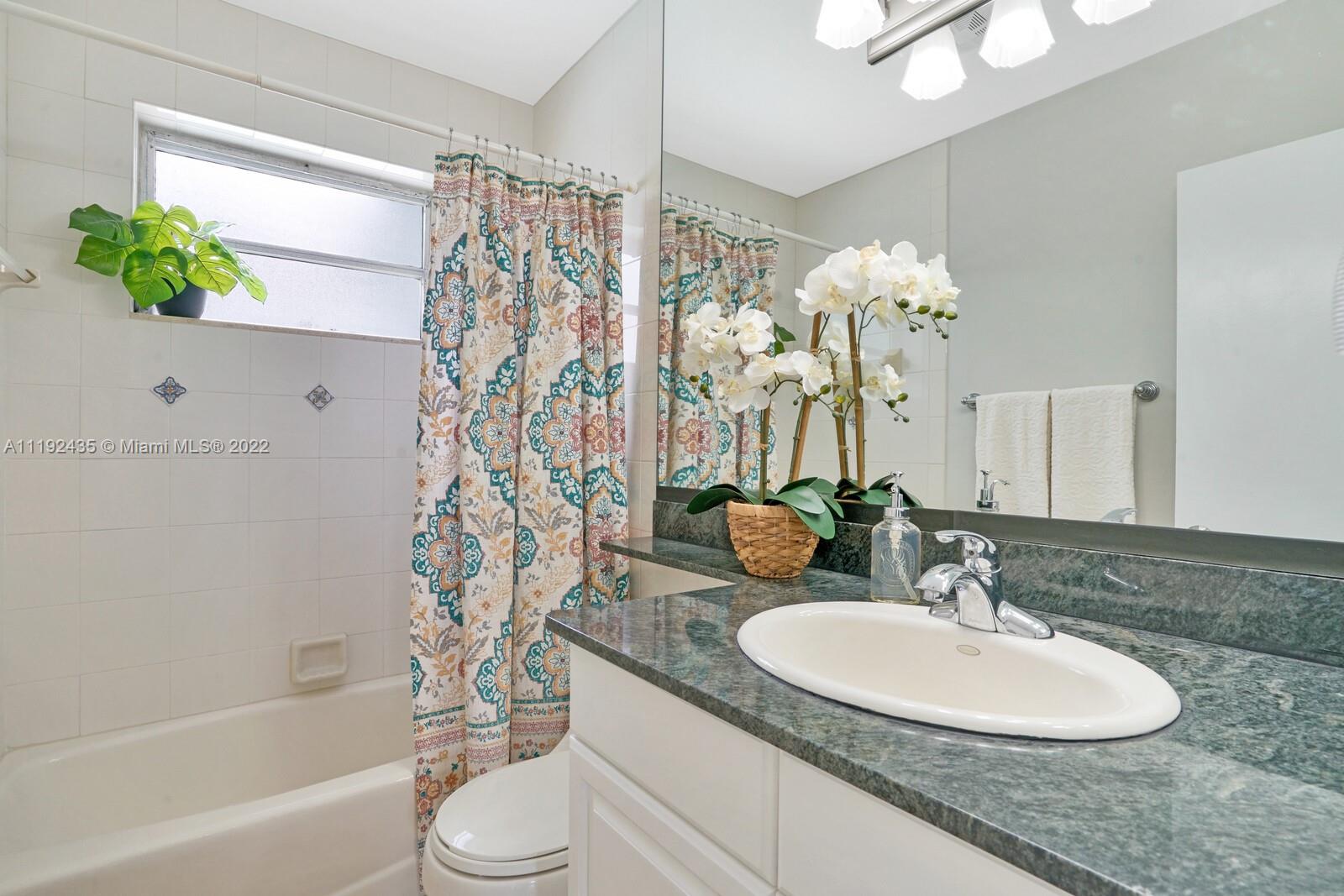5211 Northeast 26th Avenue Lighthouse Point, FL 33064 - Photo 32 of 43 a bathroom with a granite countertop sink and a mirror