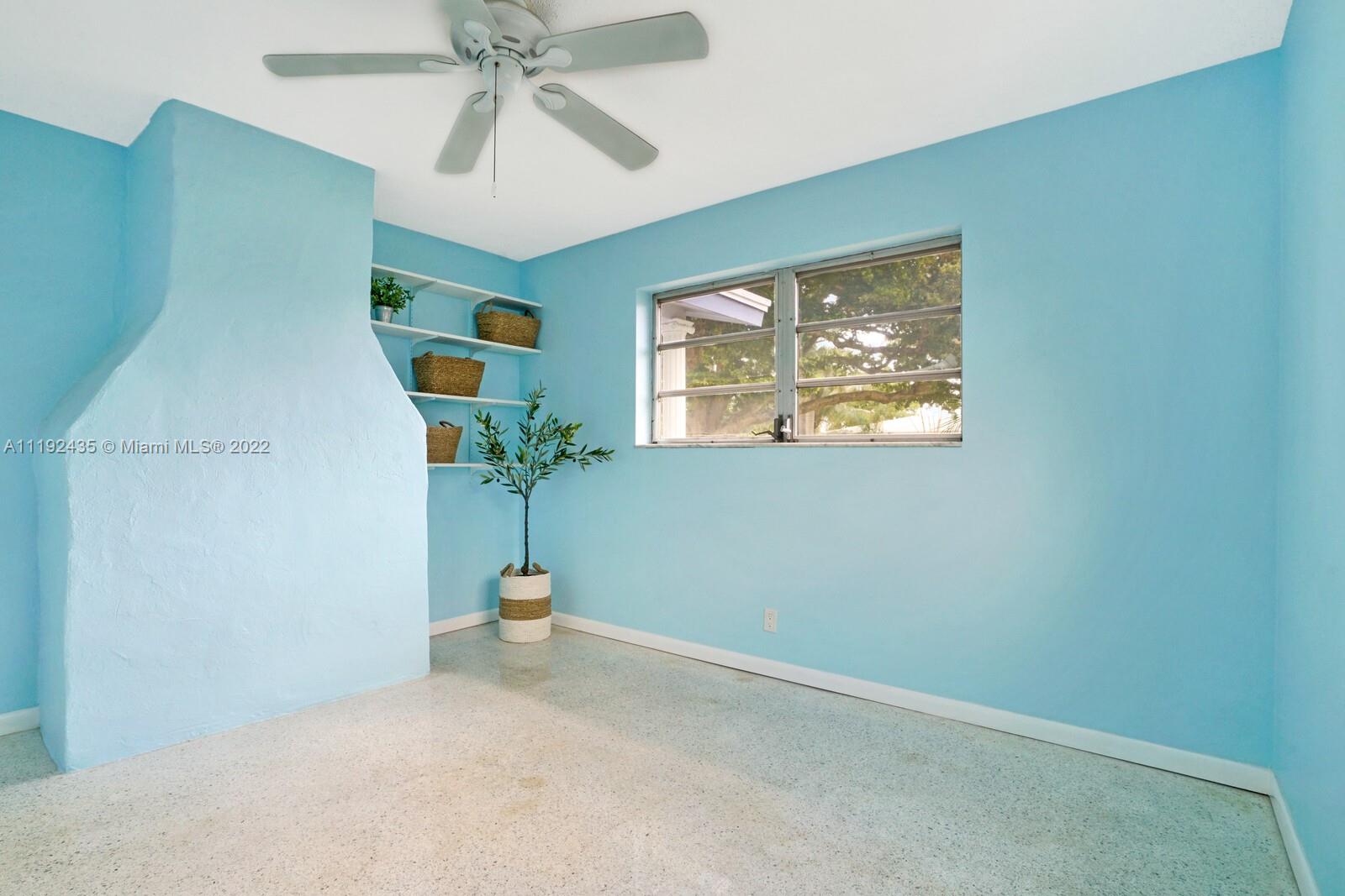 5211 Northeast 26th Avenue Lighthouse Point, FL 33064 - Photo 36 of 43 an empty room with windows and fan