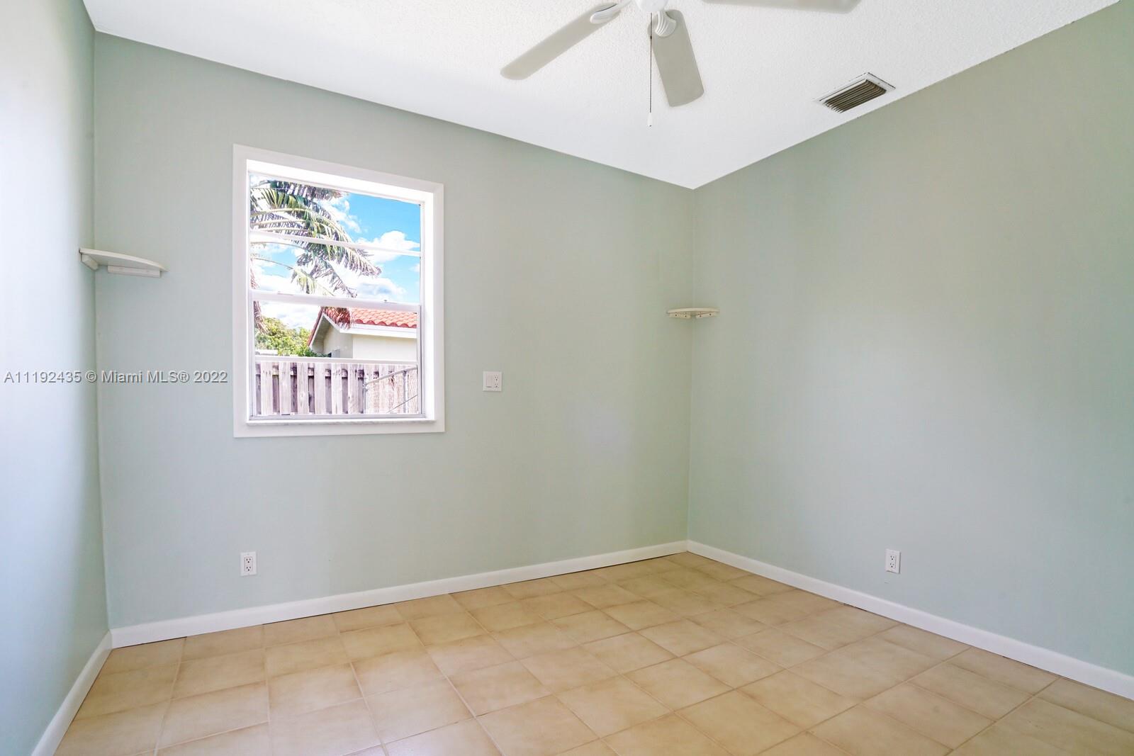 5211 Northeast 26th Avenue Lighthouse Point, FL 33064 - Photo 38 of 43 an empty room with windows