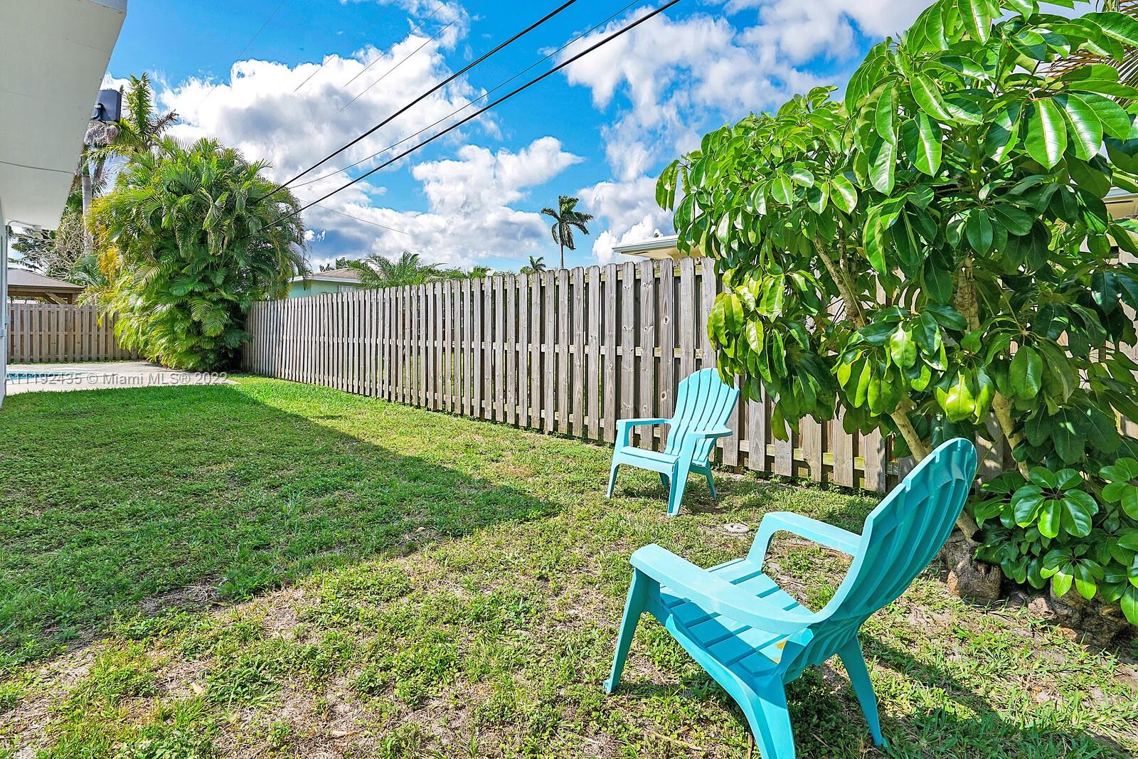 5211 Northeast 26th Avenue Lighthouse Point, FL 33064 - Photo 43 of 43 a view of a chair and table in the garden