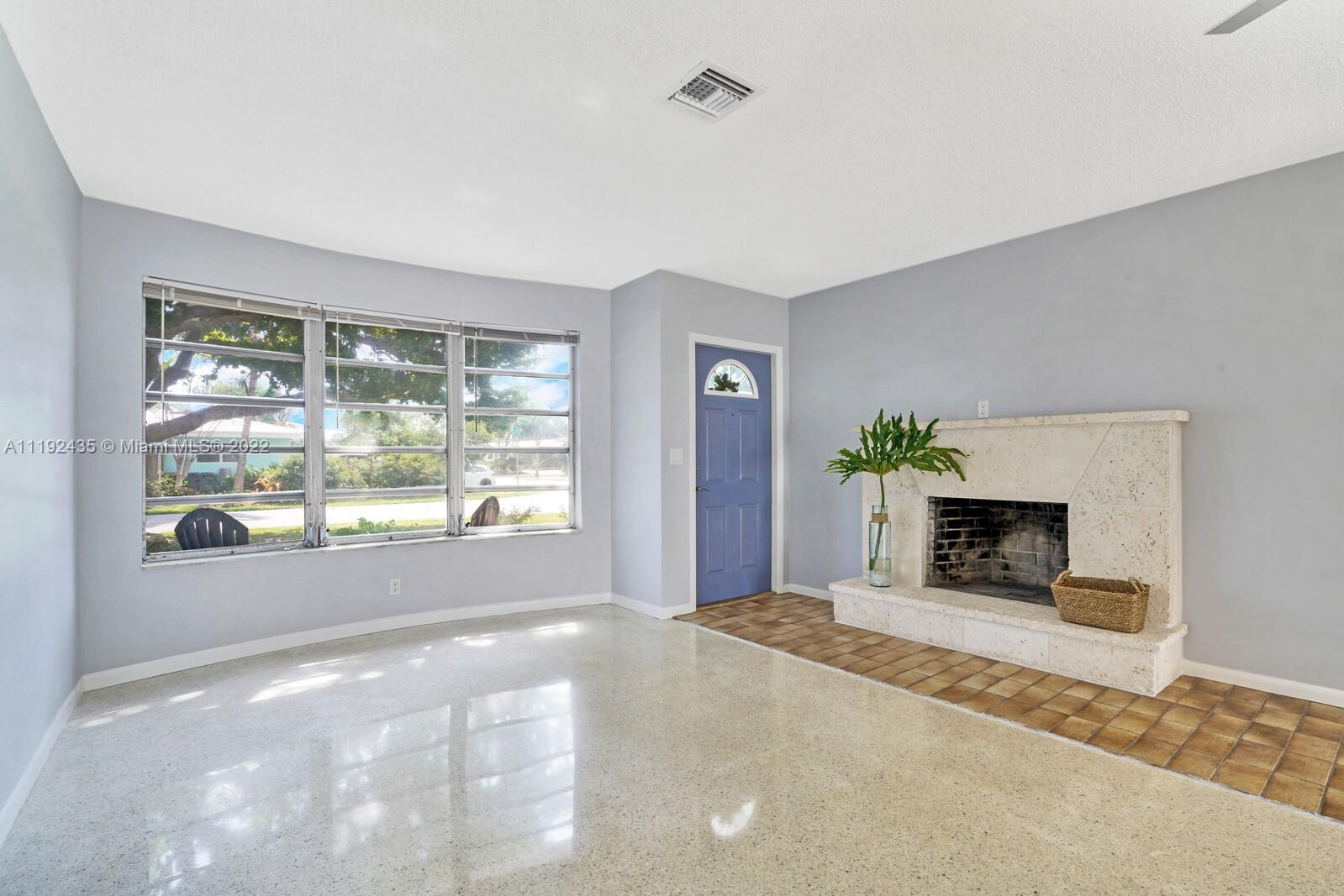 5211 Northeast 26th Avenue Lighthouse Point, FL 33064 - Photo 6 of 43 a view of a livingroom with a fireplace and window