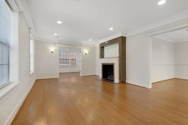 a view of an empty room with a fireplace and a window