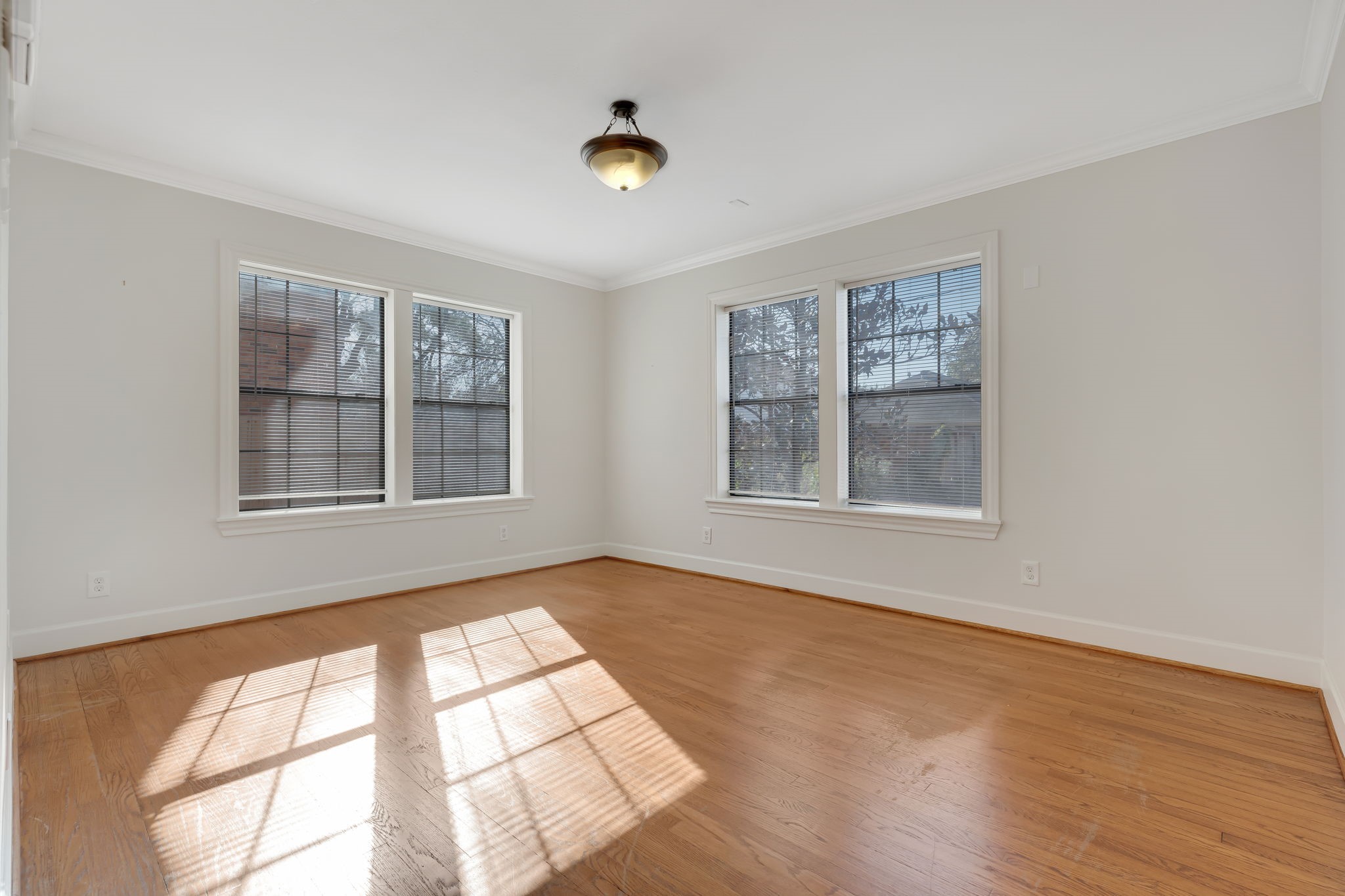 2306 Blodgett Street, Unit 1 Houston, TX 77004 - Photo 9 of 11 an empty room with wooden floor and windows