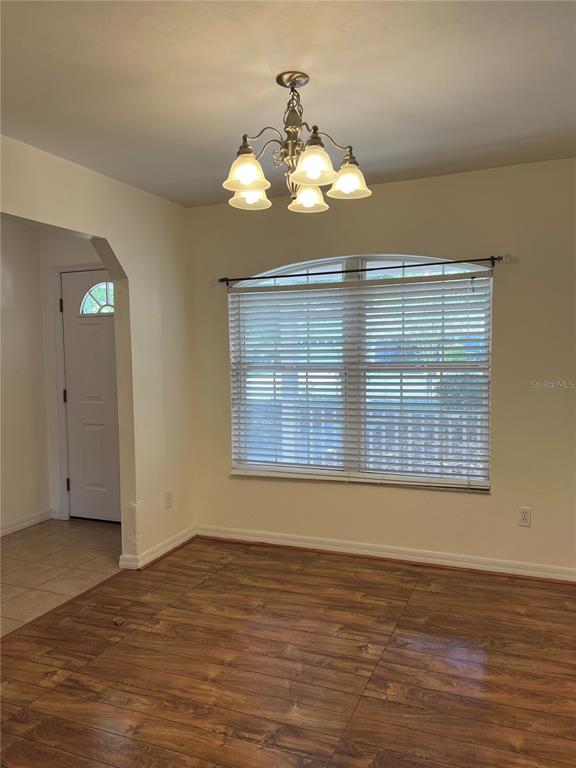 19430 Northwest 164th Road High Springs, FL 32643 - Photo 11 of 24 a view of an empty room with wooden floor and a window