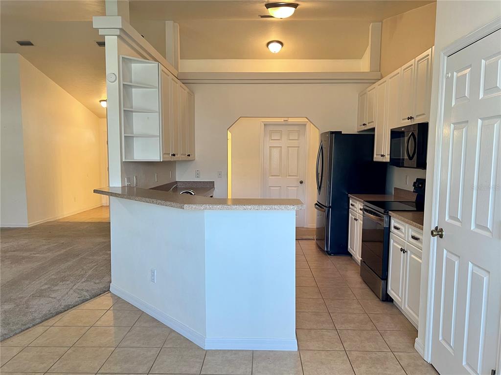 19430 Northwest 164th Road High Springs, FL 32643 - Photo 5 of 24 a kitchen with stainless steel appliances granite countertop a refrigerator a stove and a sink