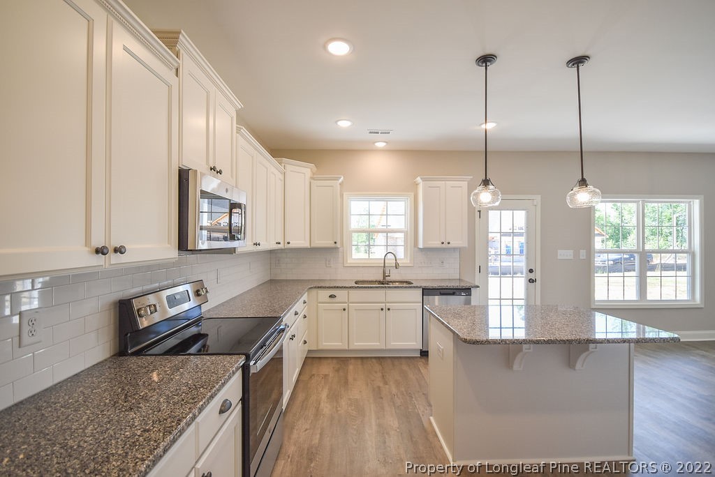 668 Townsend Road Raeford, NC 28376 - Photo 4 of 14 a kitchen with lots of counter top space and wooden floor