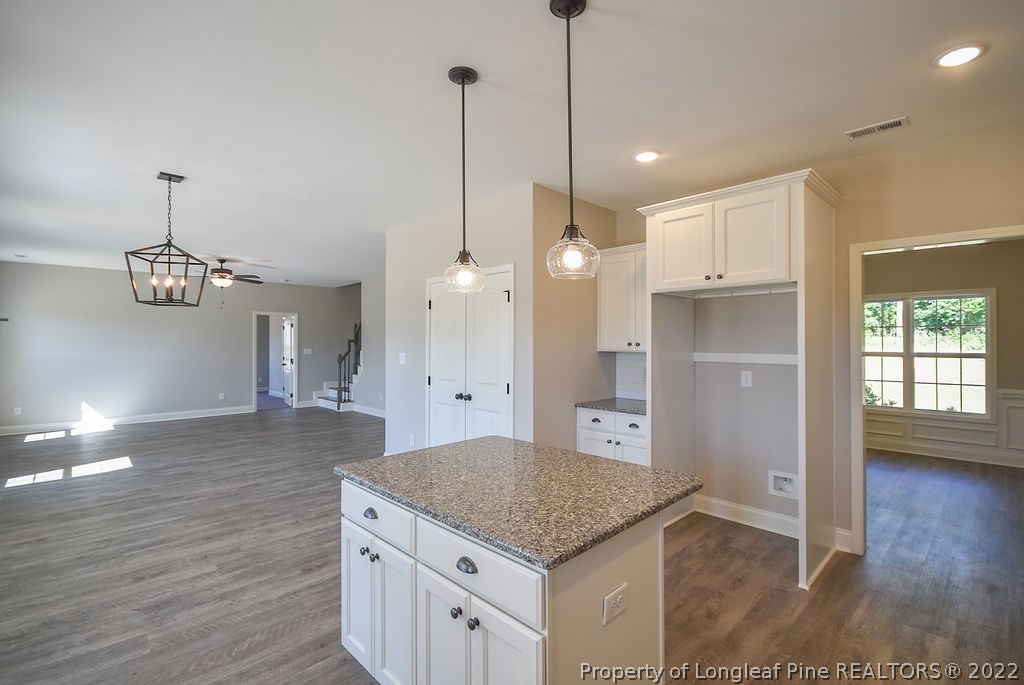 668 Townsend Road Raeford, NC 28376 - Photo 5 of 14 a kitchen with stainless steel appliances granite countertop a sink a refrigerator a stove and a wooden floors