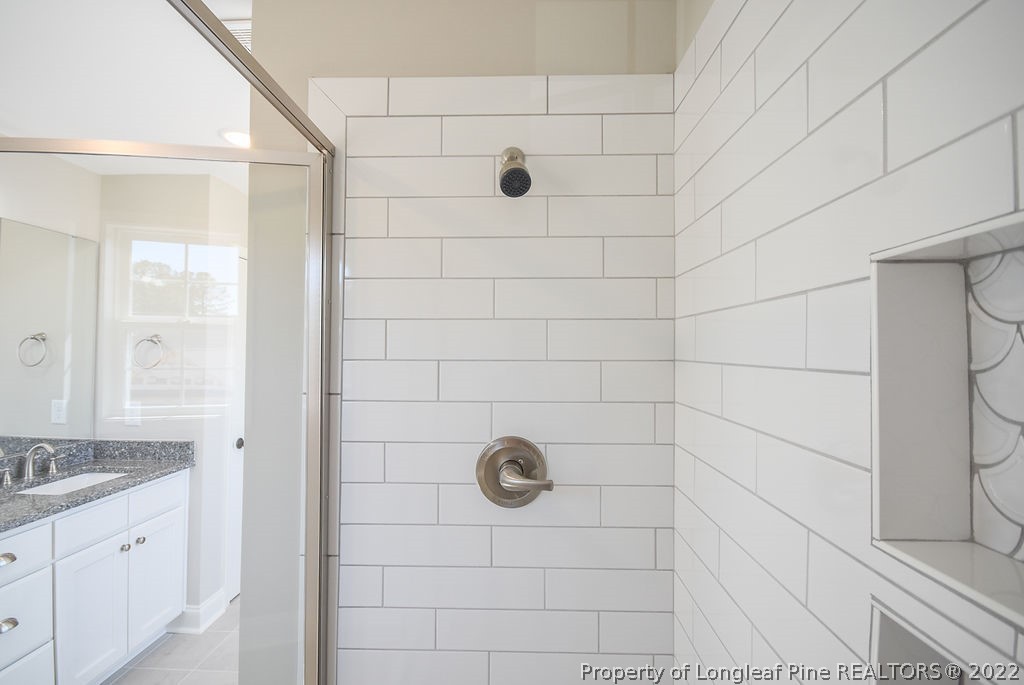 668 Townsend Road Raeford, NC 28376 - Photo 10 of 14 a bathroom with a granite countertop shower