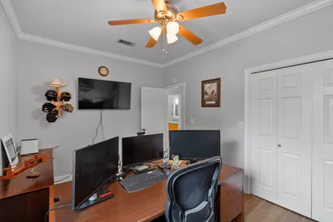 a view of a workspace with furniture and a window