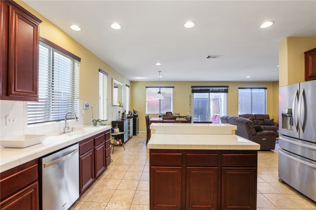 17550 Buttonwood Lane Carson, CA 90746 - Photo 13 of 43 a large kitchen with kitchen island a sink stainless steel appliances and furniture