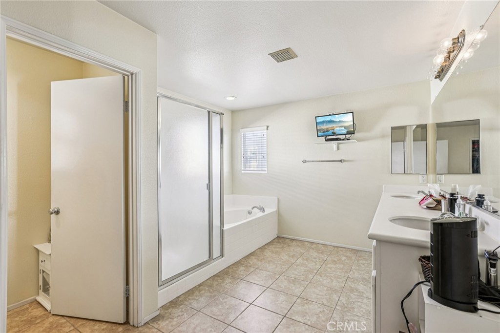 17550 Buttonwood Lane Carson, CA 90746 - Photo 18 of 43 a spacious bathroom with a sink a mirror and a shower