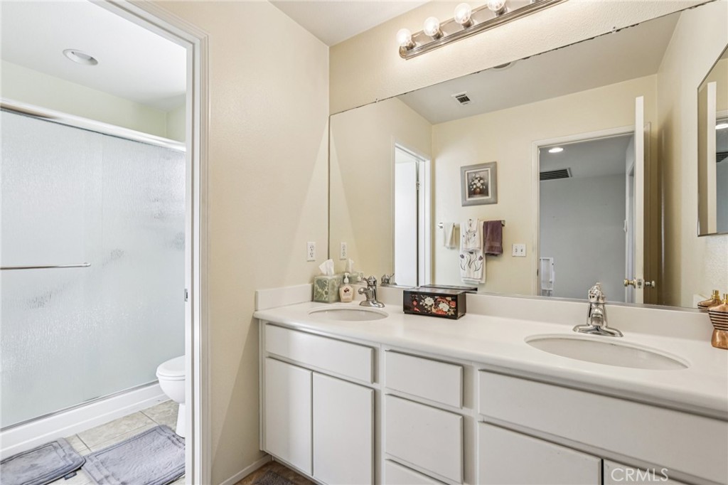 17550 Buttonwood Lane Carson, CA 90746 - Photo 25 of 43 a bathroom with a double vanity sink and mirror