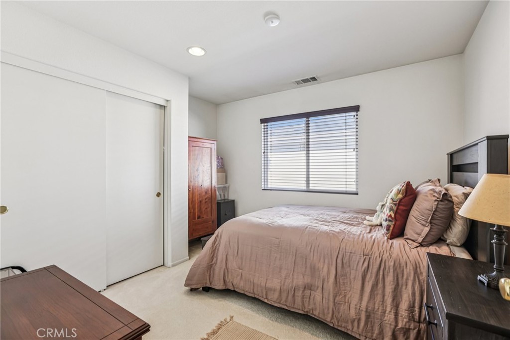 17550 Buttonwood Lane Carson, CA 90746 - Photo 30 of 43 a bedroom with a bed and a lamp with the wooden floor