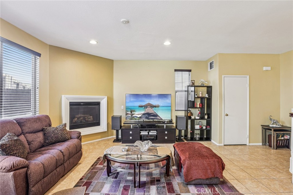 17550 Buttonwood Lane Carson, CA 90746 - Photo 3 of 43 a living room with furniture a fireplace and a flat screen tv