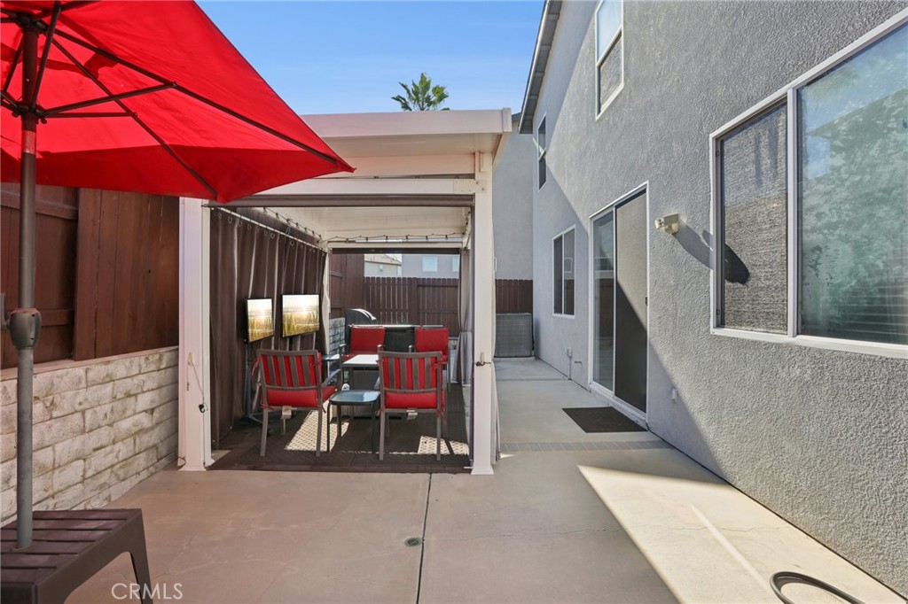 17550 Buttonwood Lane Carson, CA 90746 - Photo 35 of 43 a view of a patio with table and chairs under an umbrella