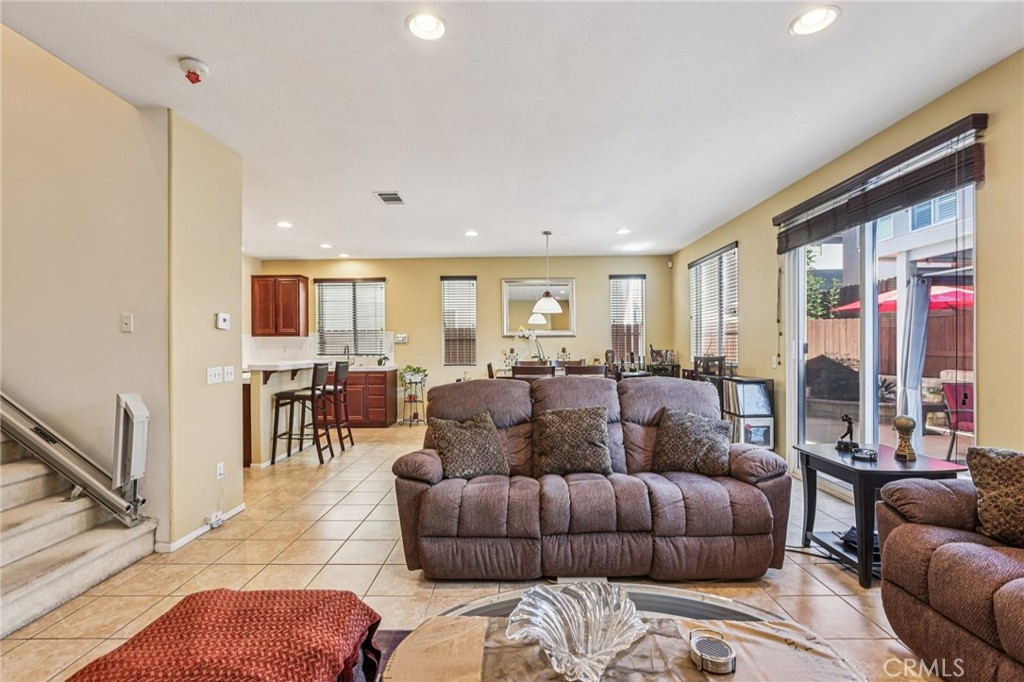 17550 Buttonwood Lane Carson, CA 90746 - Photo 6 of 43 a living room with furniture ceiling fan and a rug