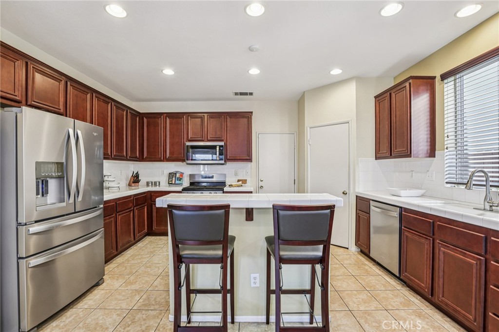 17550 Buttonwood Lane Carson, CA 90746 - Photo 10 of 43 a kitchen with a sink a counter top stainless steel appliances and cabinets