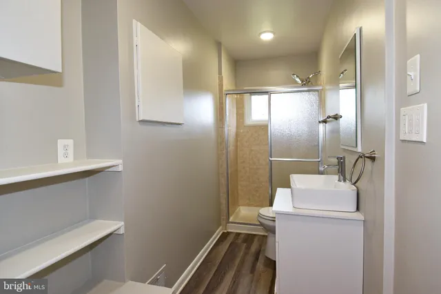 a bathroom with a sink toilet and shower