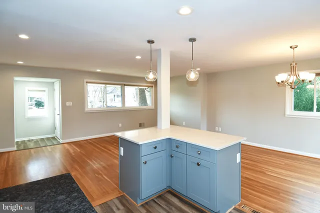 a view of a kitchen cabinets and chandelier