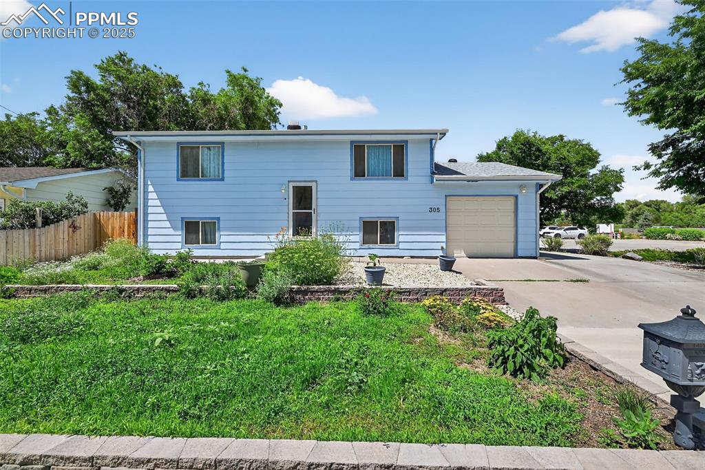 305 Iris Drive Fountain, CO 80817 - Photo 1 of 22 a front view of a house with garden
