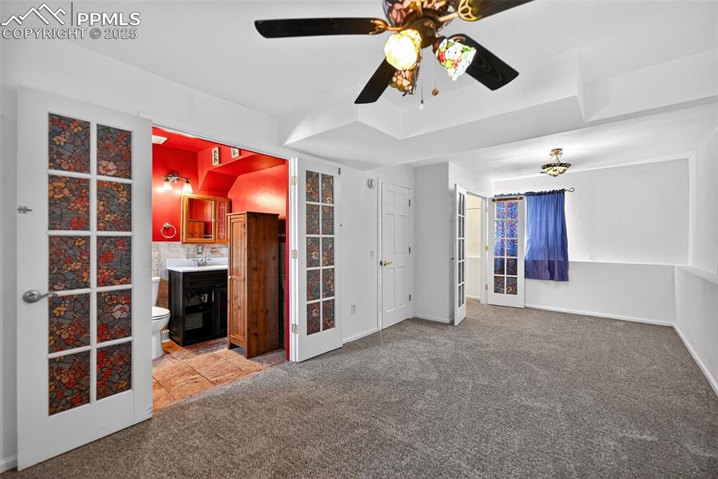 305 Iris Drive Fountain, CO 80817 - Photo 14 of 22 a view of an empty room with a ceiling fan and window