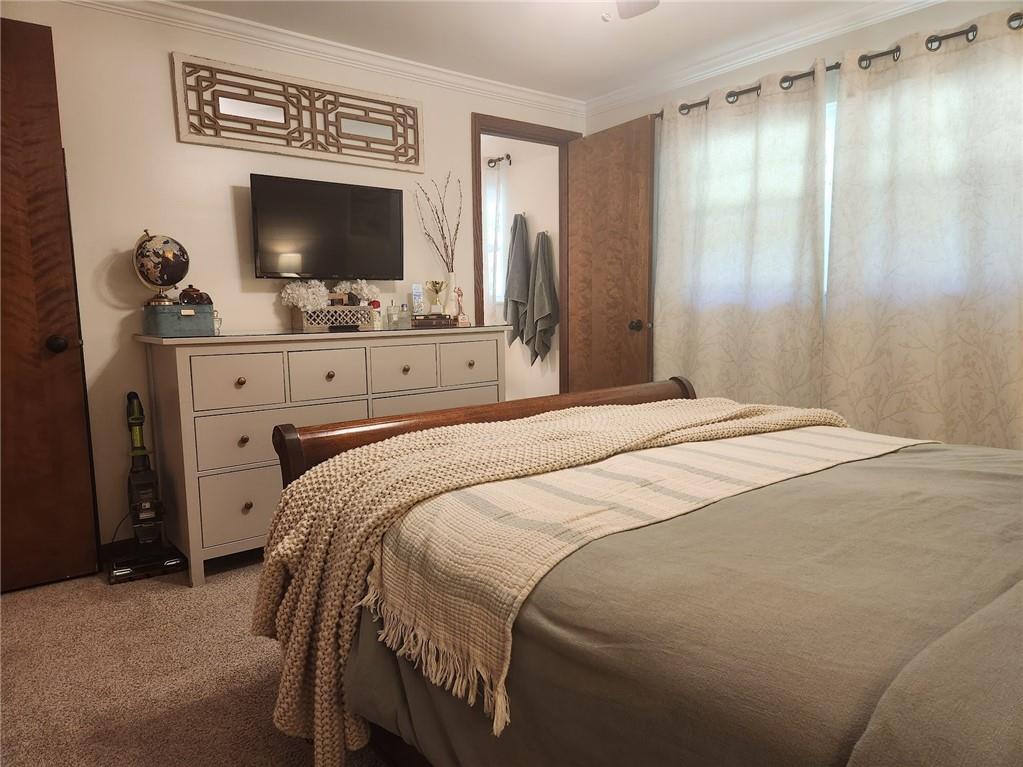 268 Old Plank Road Butler, PA 16002 - Photo 25 of 41 a bedroom with a bed and a flat tv screen on dresser