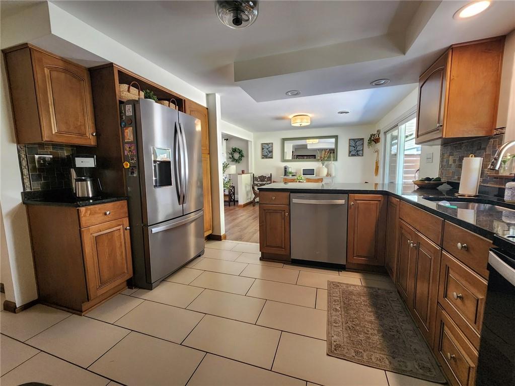 268 Old Plank Road Butler, PA 16002 - Photo 8 of 41 a kitchen with stainless steel appliances granite countertop a refrigerator and wooden cabinets