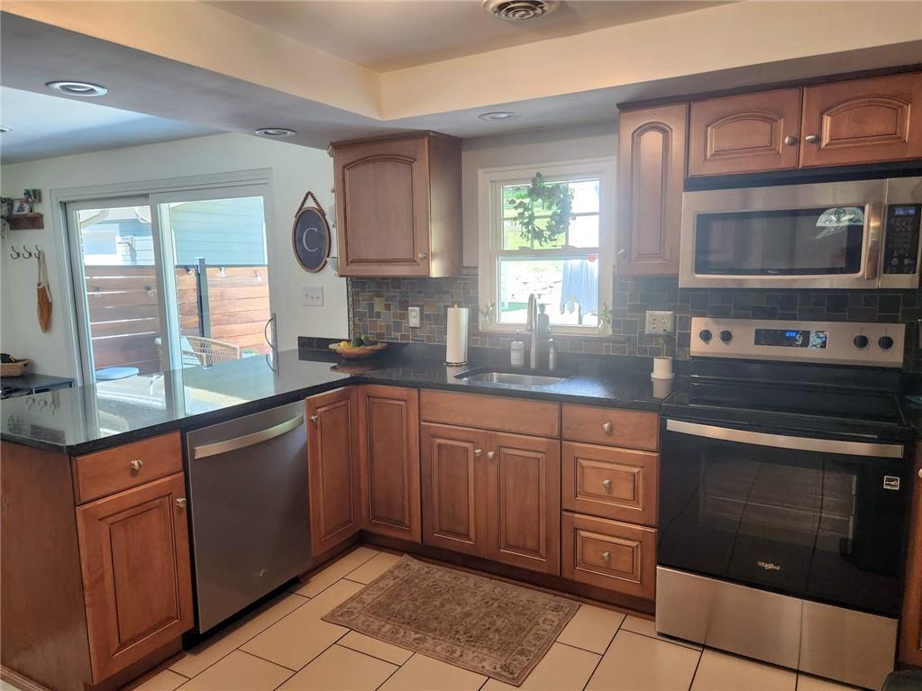 268 Old Plank Road Butler, PA 16002 - Photo 9 of 41 a kitchen with stainless steel appliances granite countertop wooden cabinets a sink and a stove