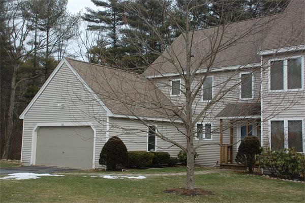 a view of a white house with a yard