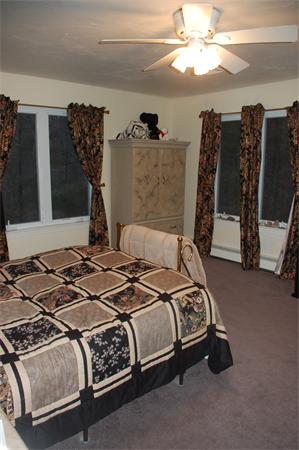 11 Longley Road, Unit G1 Shirley, MA 01464 - Photo 6 of 12 a bedroom with a bed and a chandelier