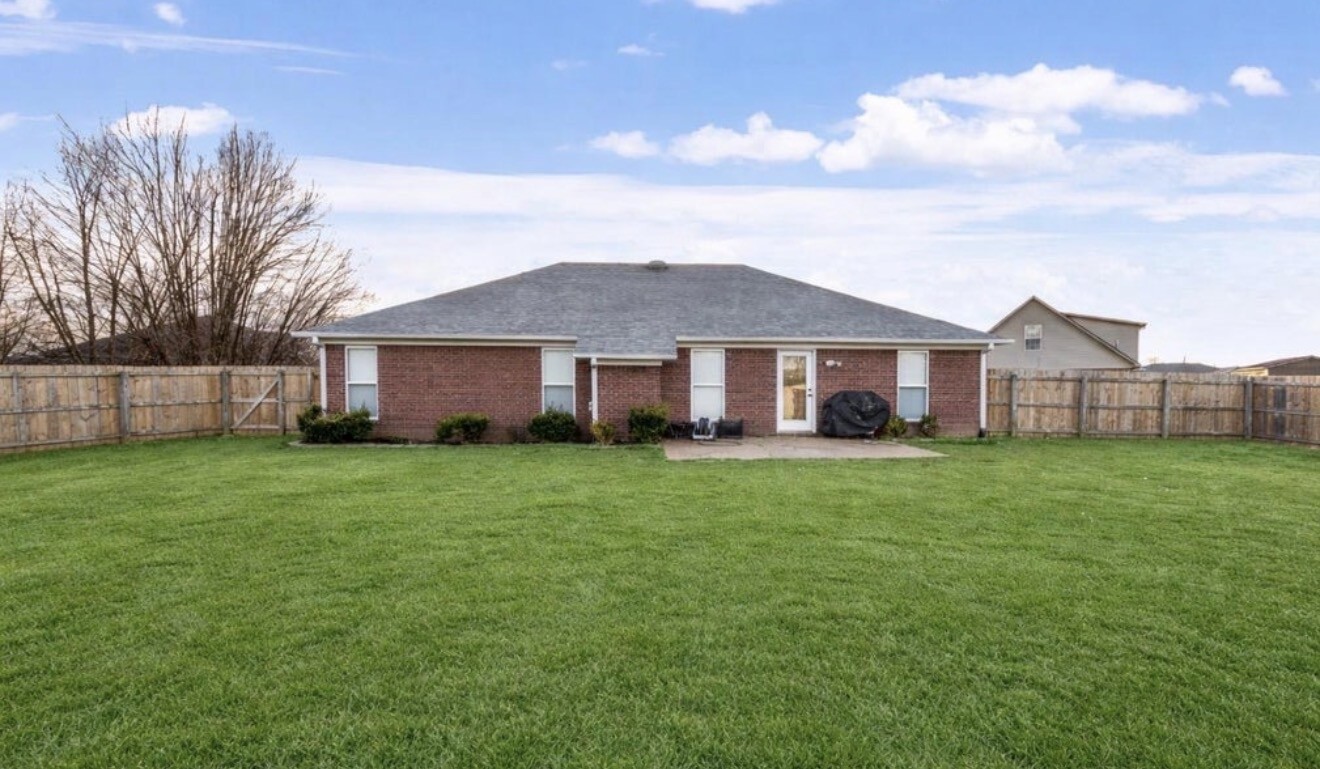 23 Matrix Cove Jackson, TN 38305 - Photo 2 of 16 a view of a yard in front of a house with a large tree