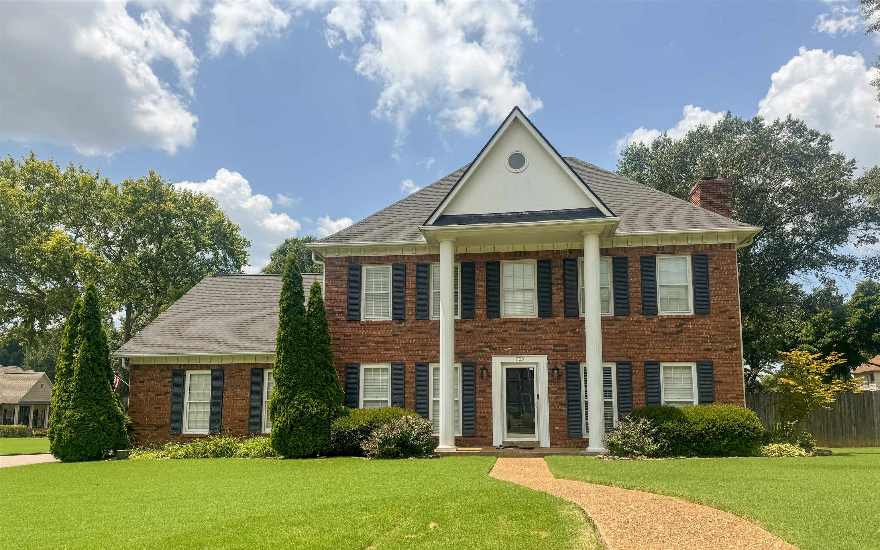 a front view of a house with garden