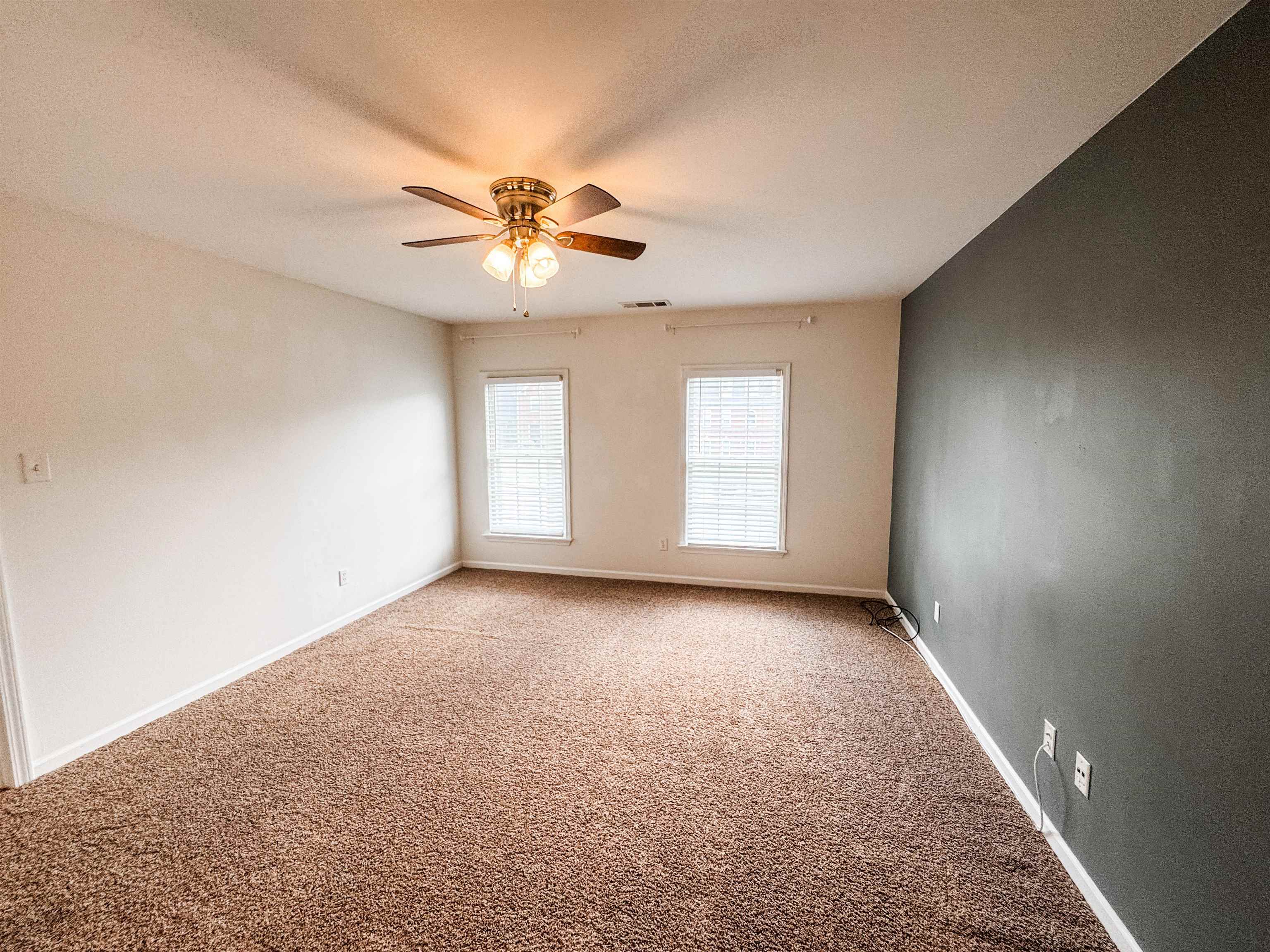705 Cotham Drive Collierville, TN 38017 - Photo 18 of 22 an empty room with windows and fan
