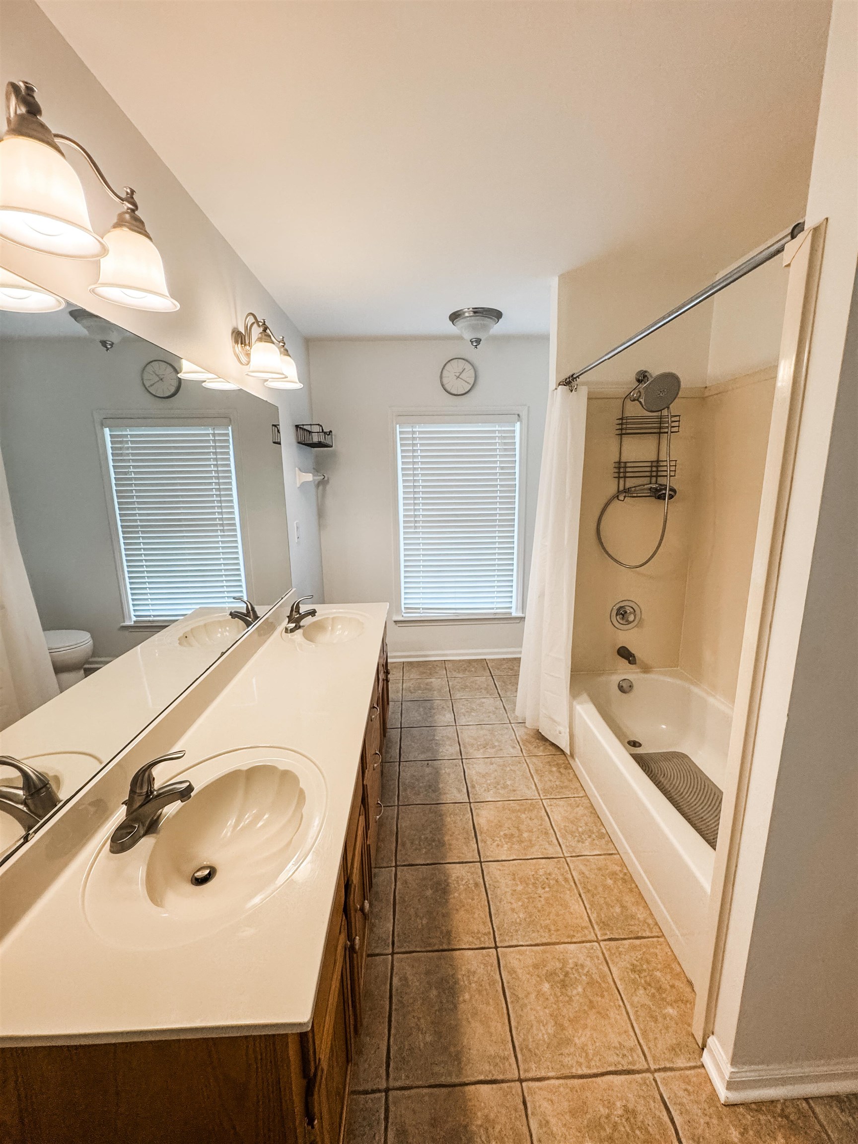 705 Cotham Drive Collierville, TN 38017 - Photo 19 of 22 a bathroom with a bathtub shower sink and mirror