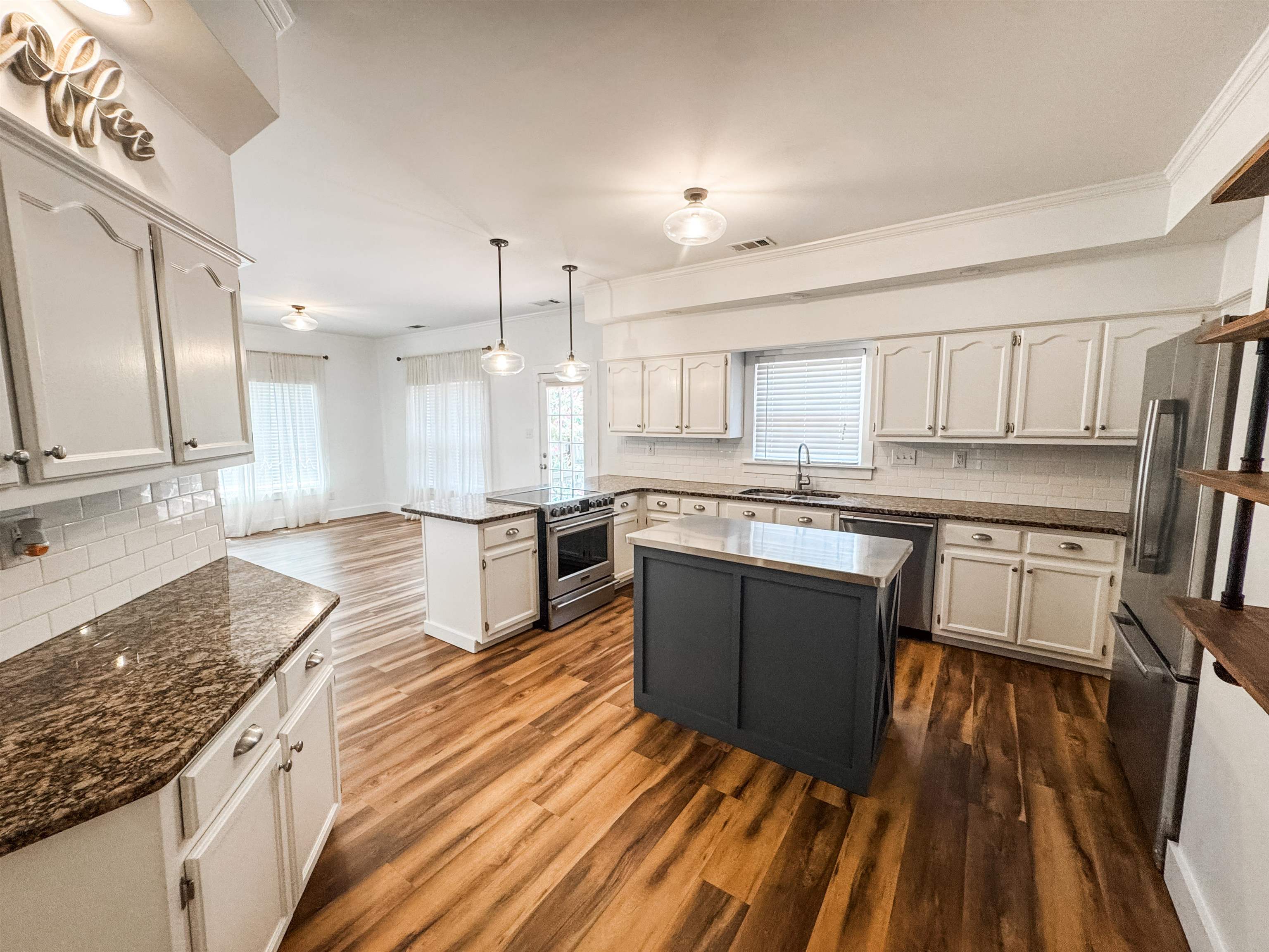 705 Cotham Drive Collierville, TN 38017 - Photo 9 of 22 a large kitchen with stainless steel appliances granite countertop a stove a sink dishwasher and a refrigerator