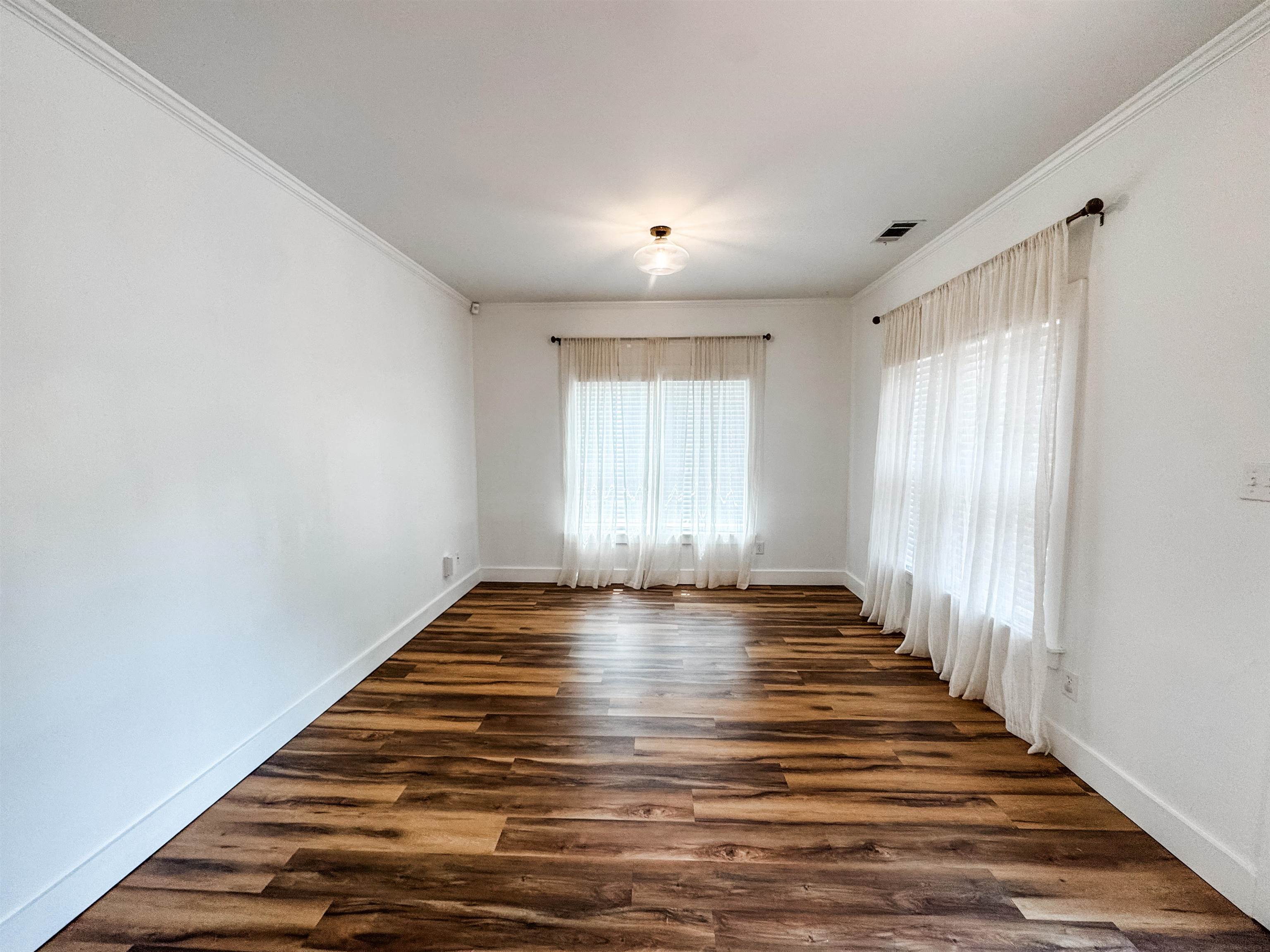705 Cotham Drive Collierville, TN 38017 - Photo 10 of 22 a view of an empty room with wooden floor and a window