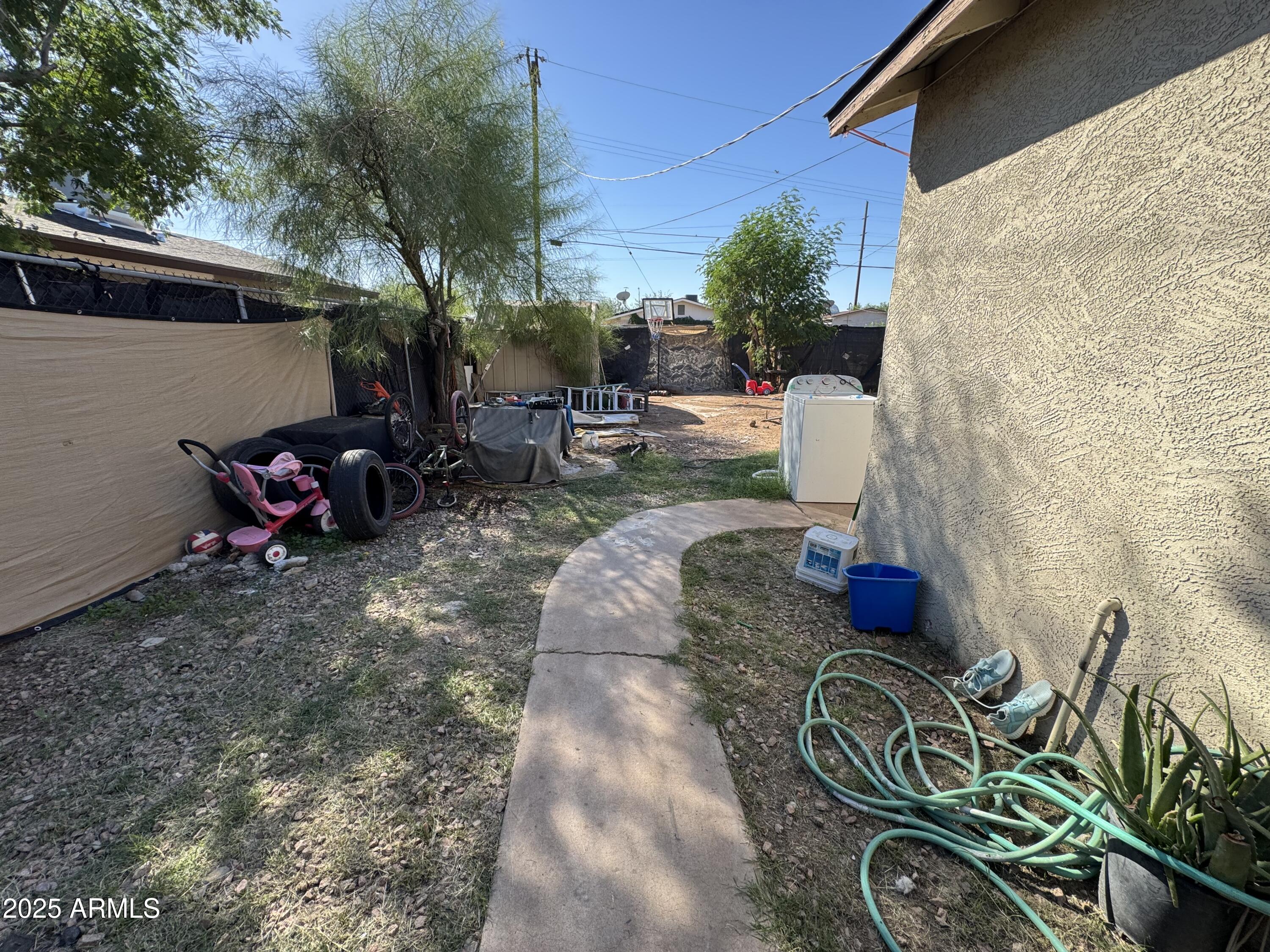 2425 West Papago Street Phoenix, AZ 85009 - Photo 15 of 16 a backyard of a house with outdoor seating