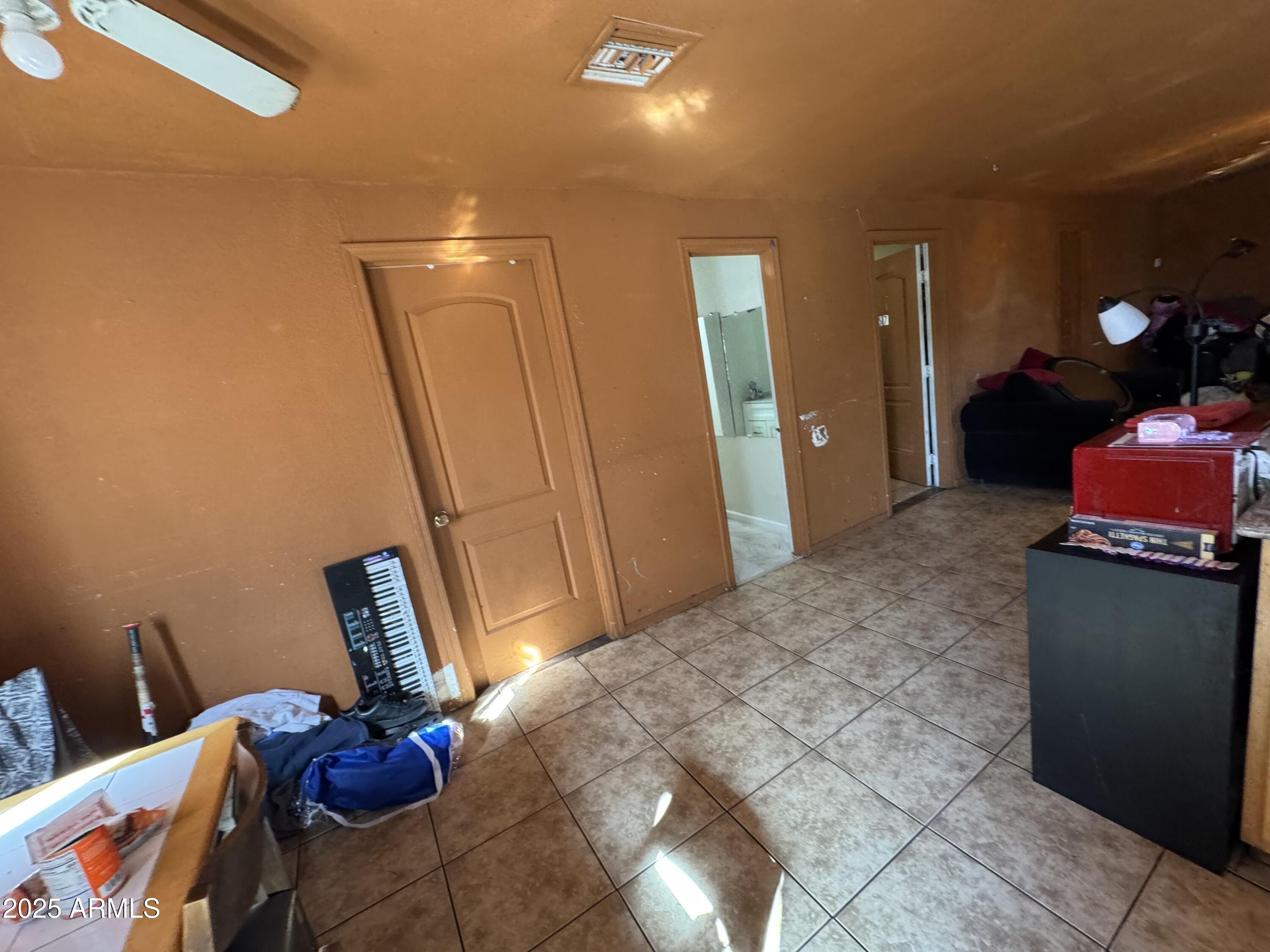 2425 West Papago Street Phoenix, AZ 85009 - Photo 3 of 16 a bedroom with a bed and wooden floor
