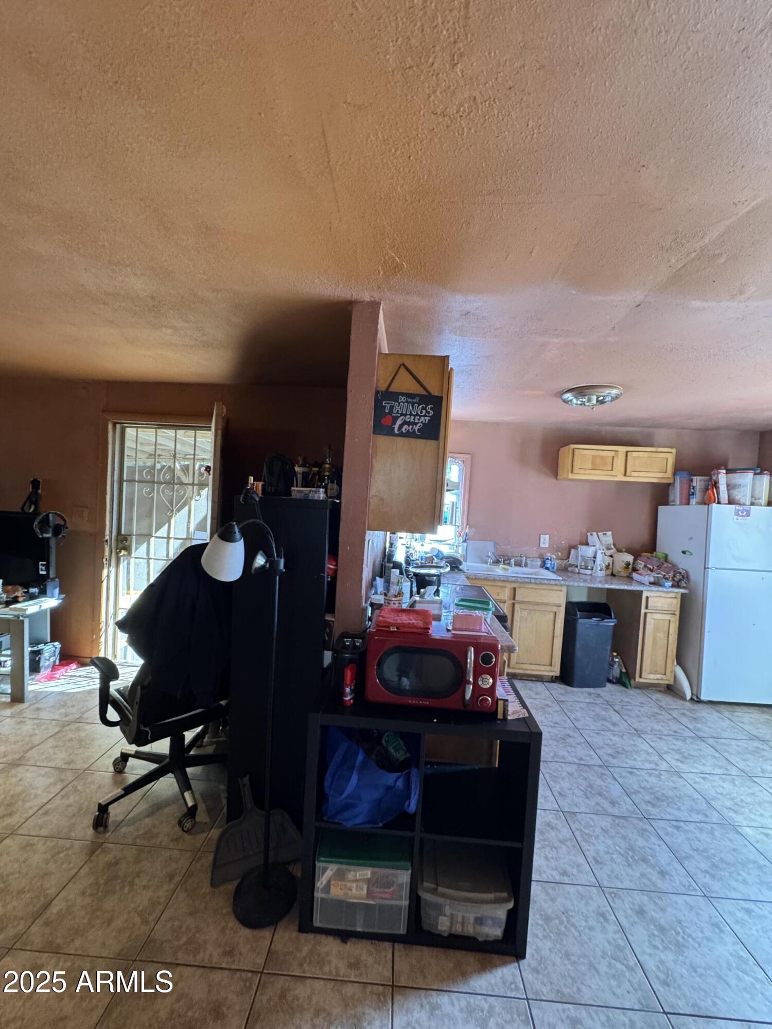 2425 West Papago Street Phoenix, AZ 85009 - Photo 6 of 16 a living room with furniture a rug and a fireplace