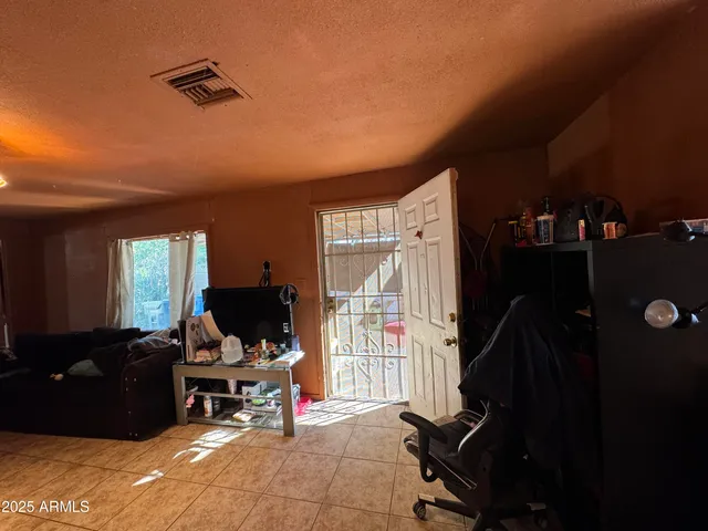 a living room with furniture rug and a window