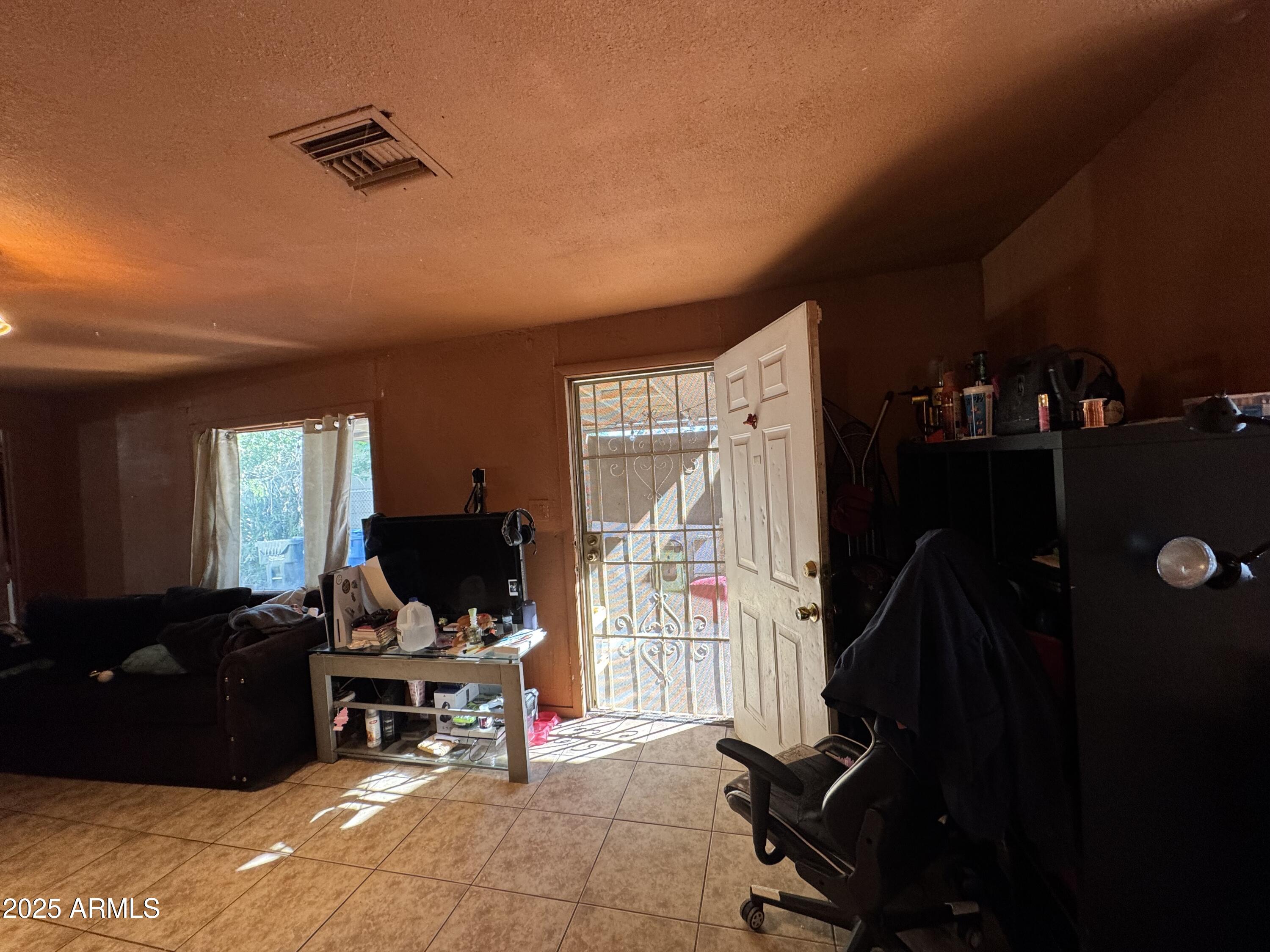 2425 West Papago Street Phoenix, AZ 85009 - Photo 7 of 16 a living room with furniture rug and a window