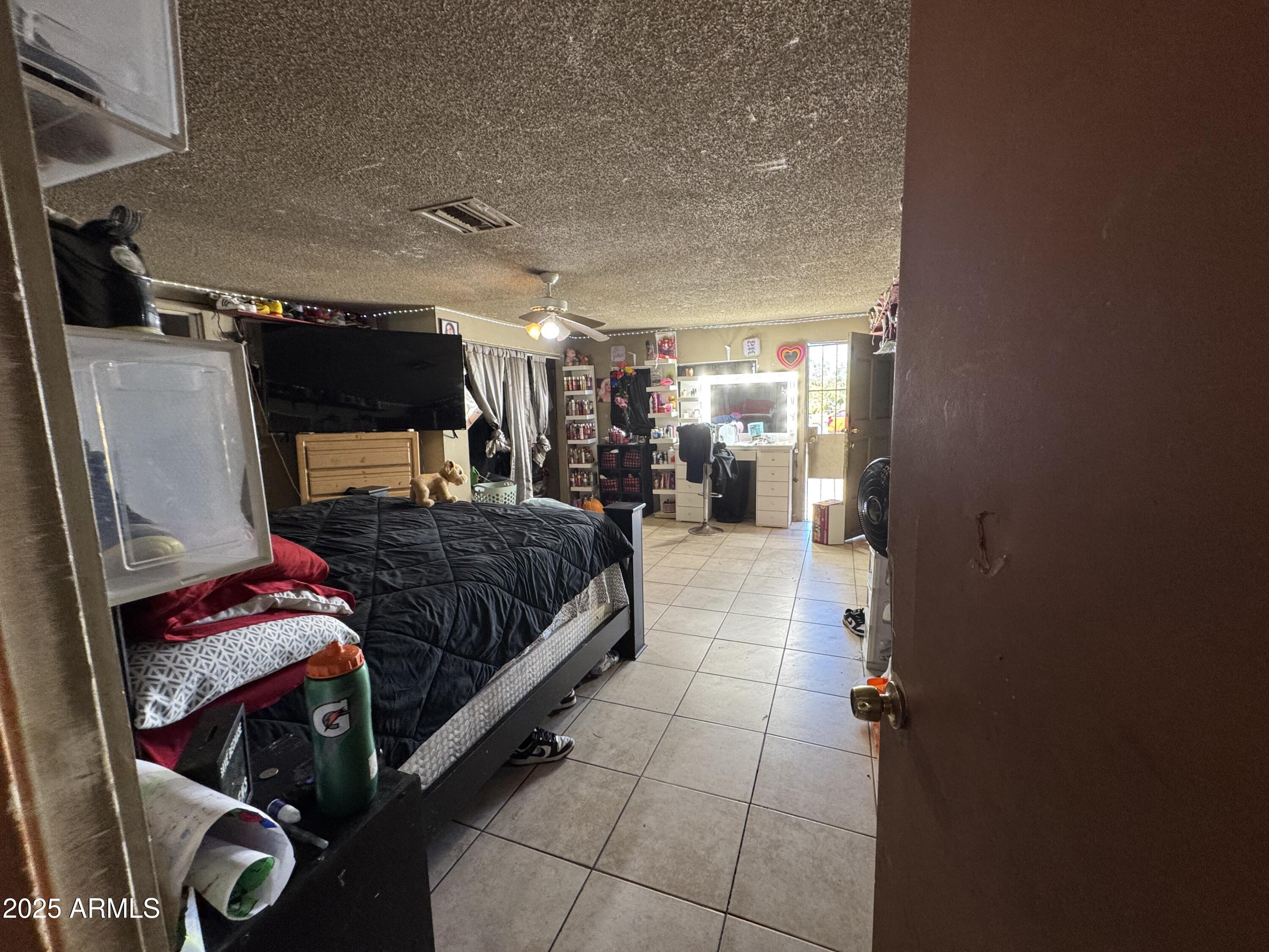 2425 West Papago Street Phoenix, AZ 85009 - Photo 10 of 16 a bedroom with a bed and a walk in closet