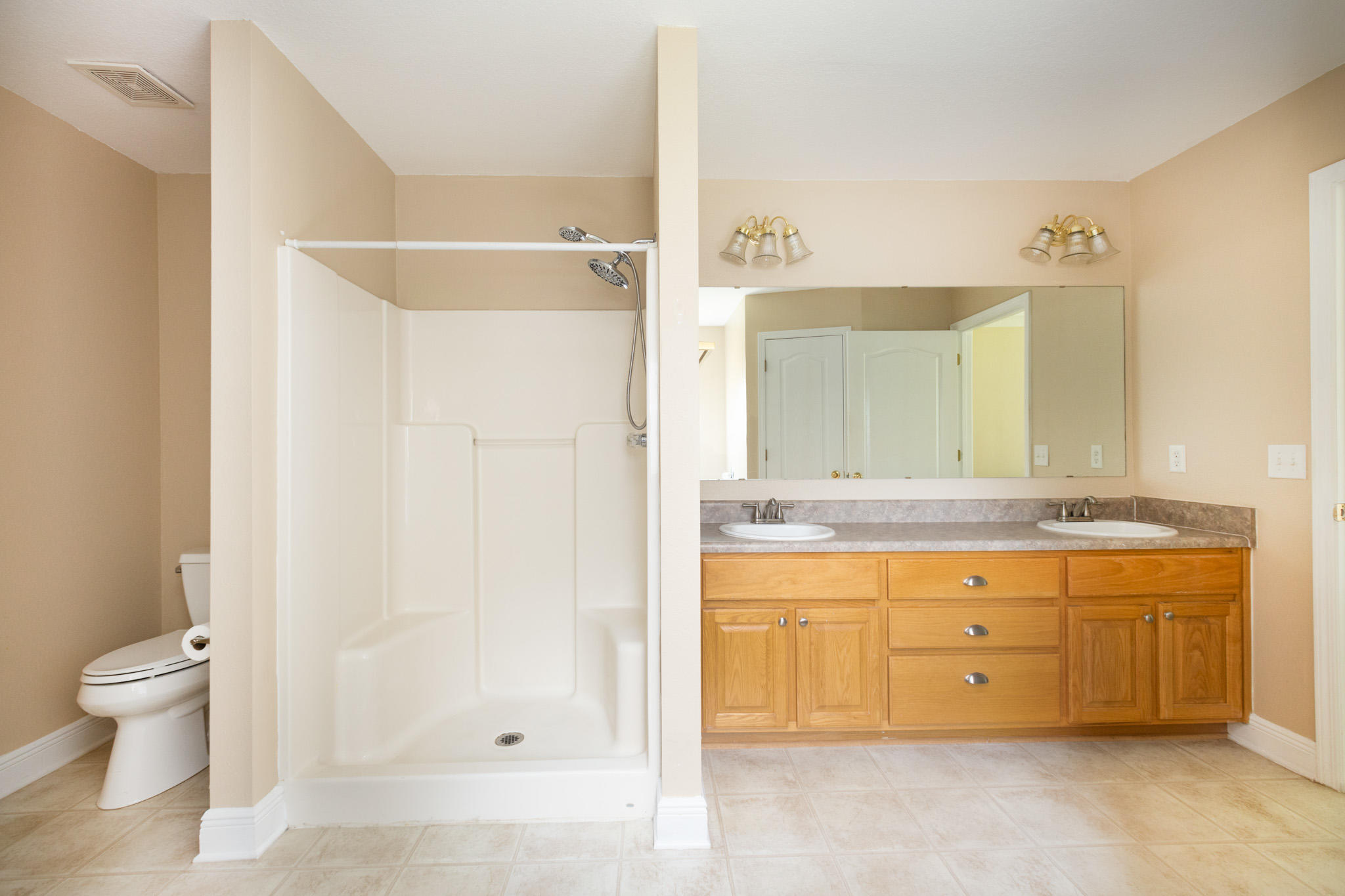 653 Territory Lane Crestview, FL 32536 - Photo 17 of 29 a bathroom with a granite countertop sink a toilet and a bathtub