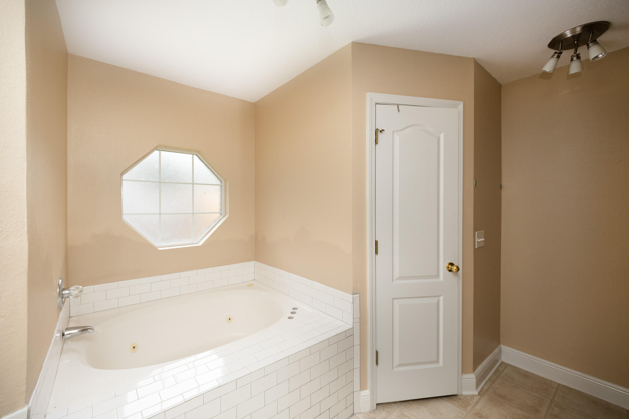 653 Territory Lane Crestview, FL 32536 - Photo 18 of 29 a bathroom with a tub a sink and a window