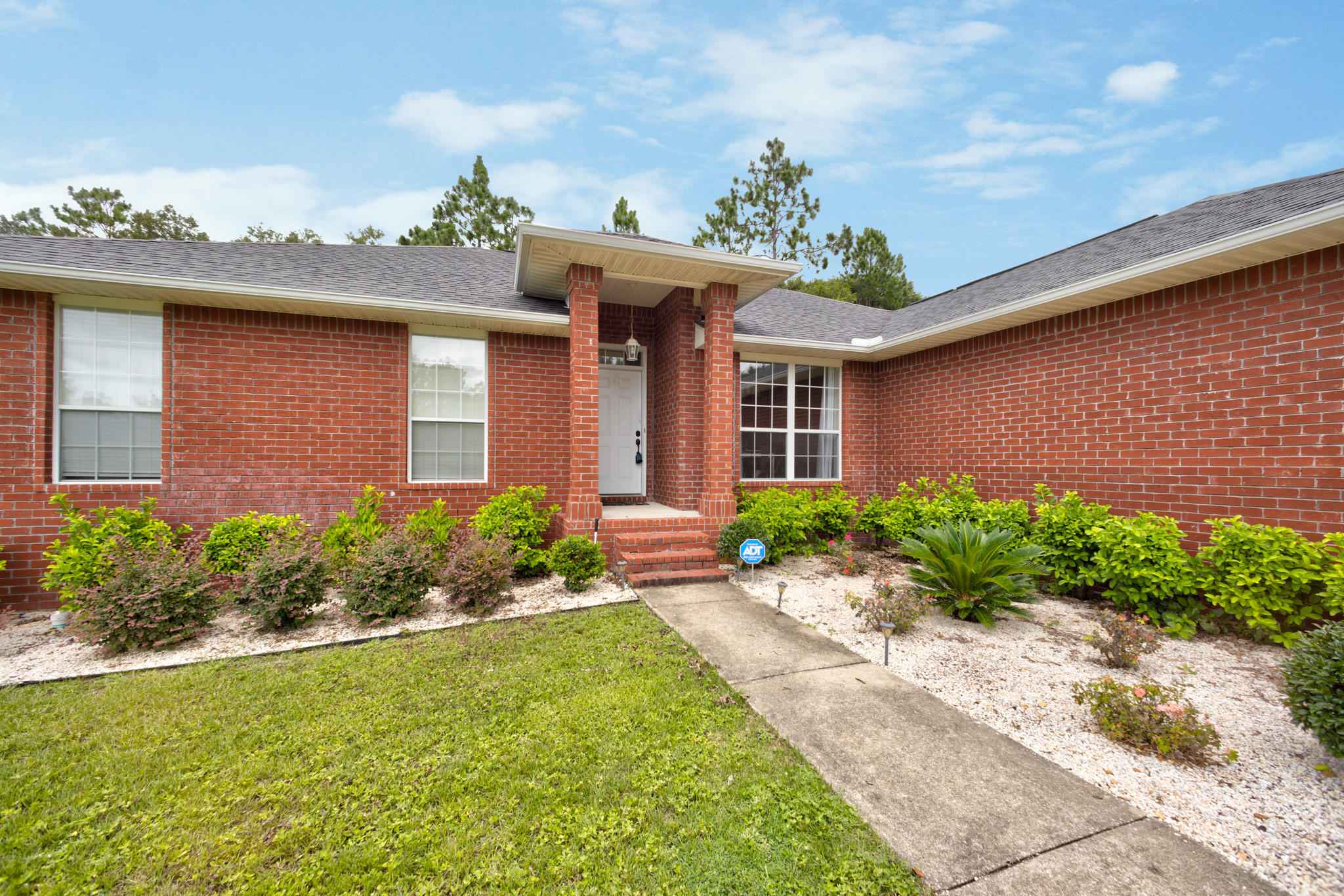 653 Territory Lane Crestview, FL 32536 - Photo 2 of 29 a front view of a house with a garden